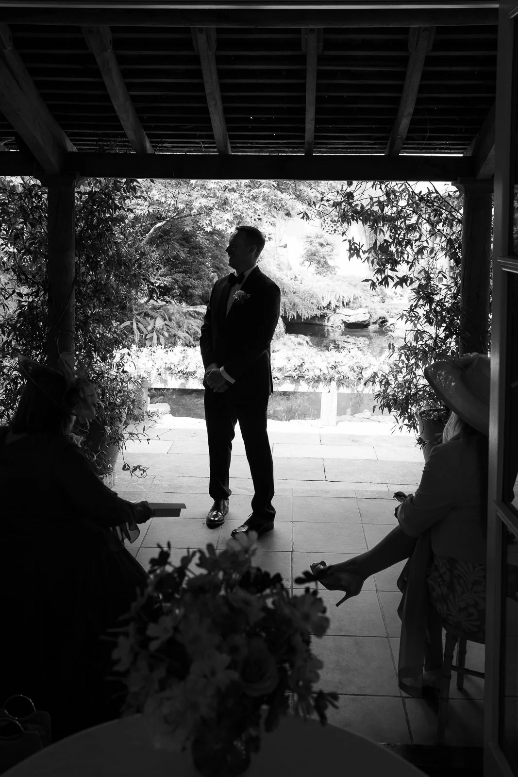 Groom silhouetted under veranda at Matara wedding ceremony