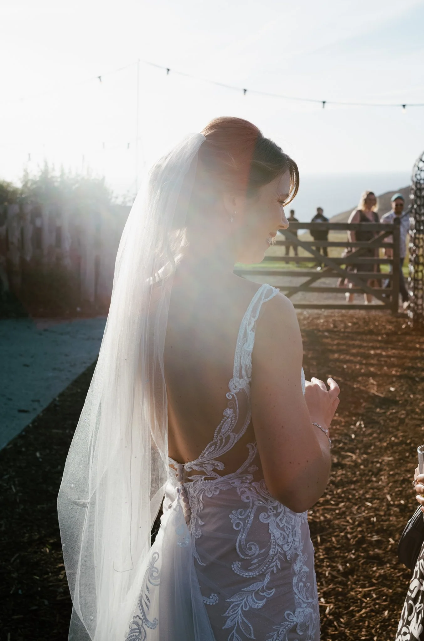 Sun flare on bride's veil at The Shed at Mwnt in Wales