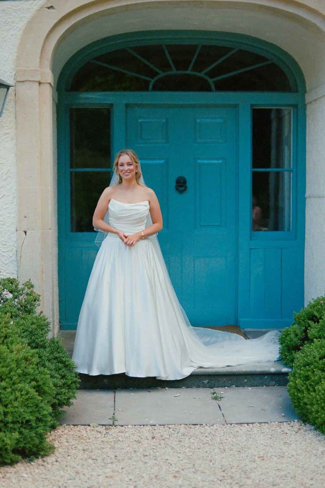 Bride in doorway of Matara manor house, film wedding photography