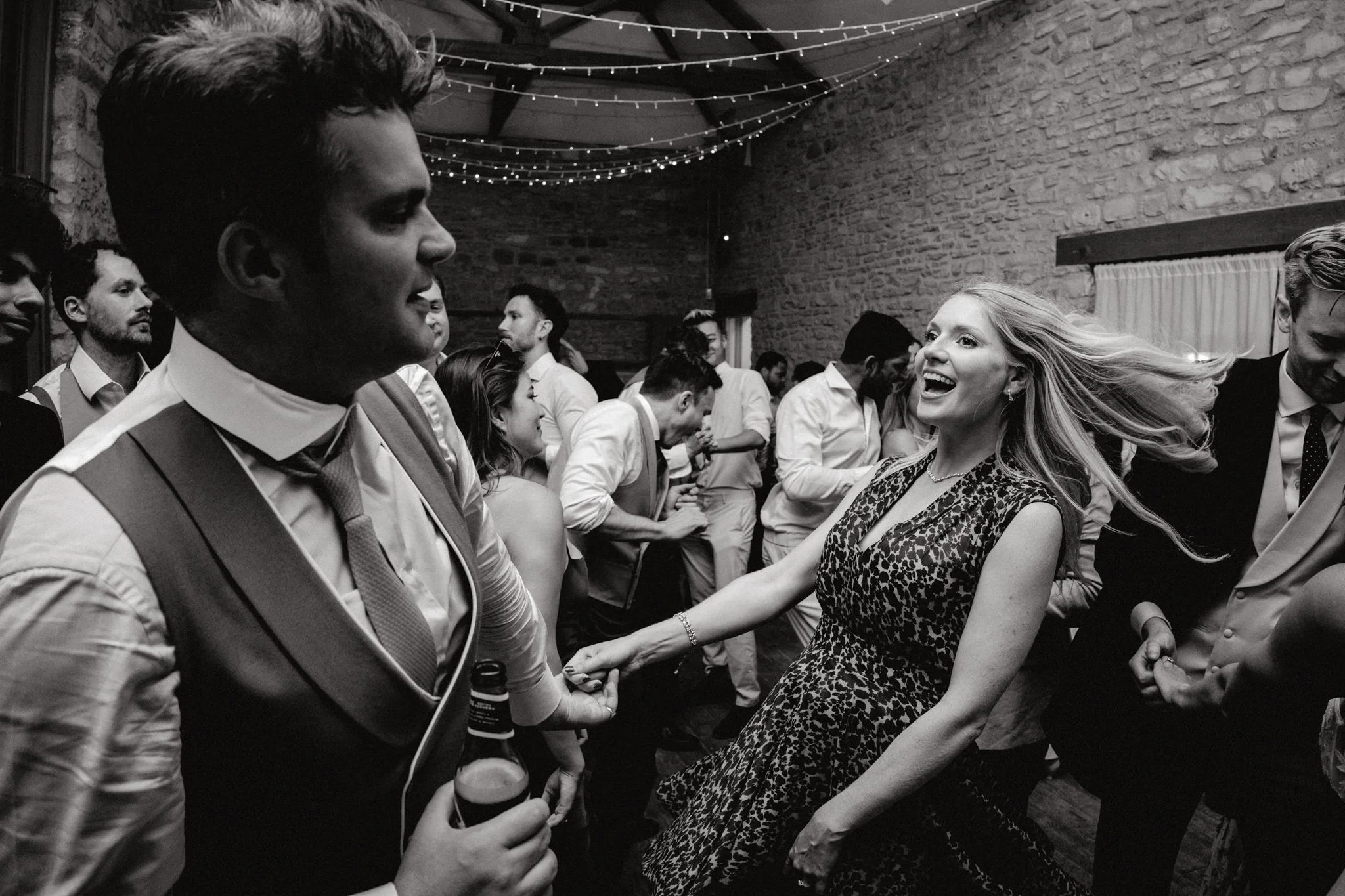 wedding photography of guests swinging around on the dancefloor at Folly Farm in bristol