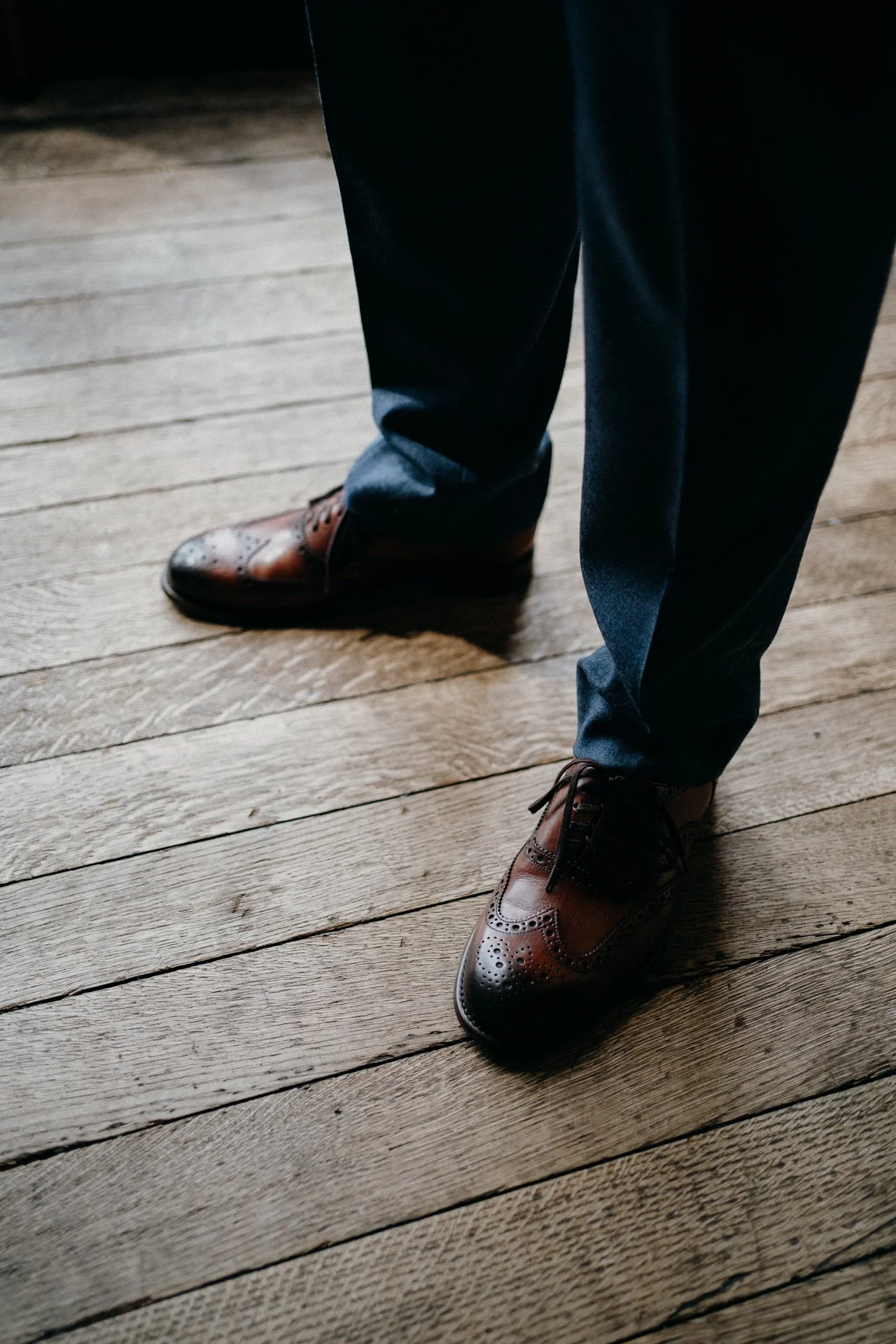 Hampton Court Castle wedding groom prep standing on floorboards