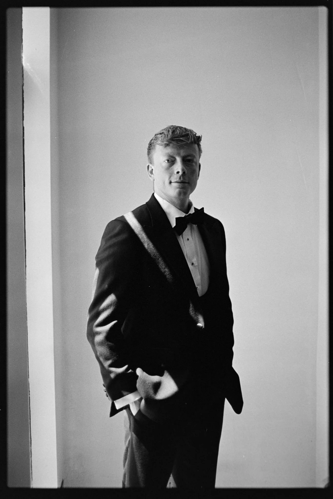 Portrait of a groom in window light on 35mm Kodak Tri-x film