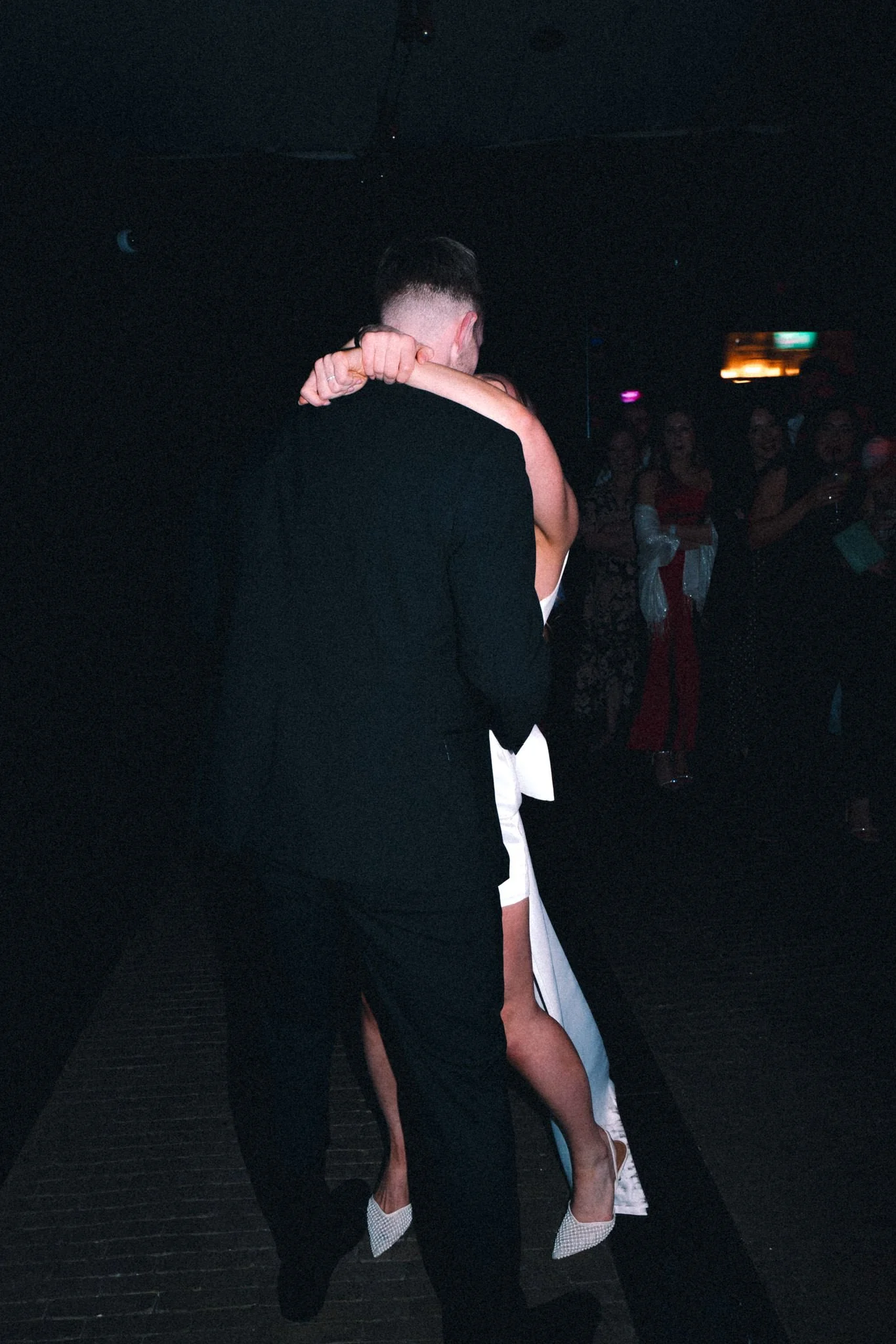 wedding photography of bride and groom dancing where the bride's dress forms a white outline of the groom