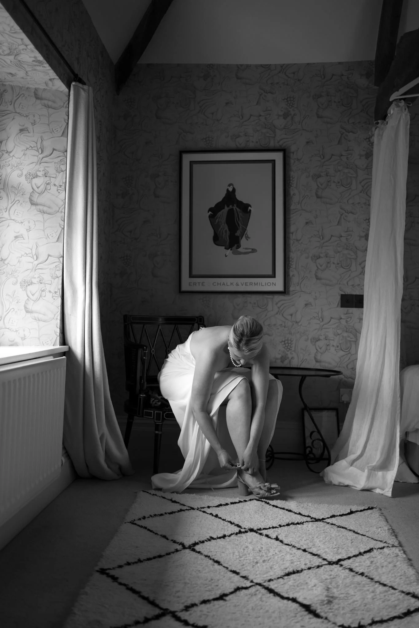 Bride puts on her shoes at Dewsall Court