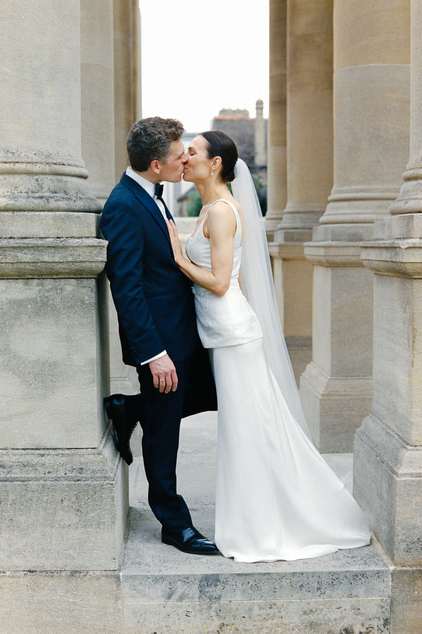 wedding photography of bride and groom kissing in Oxford
