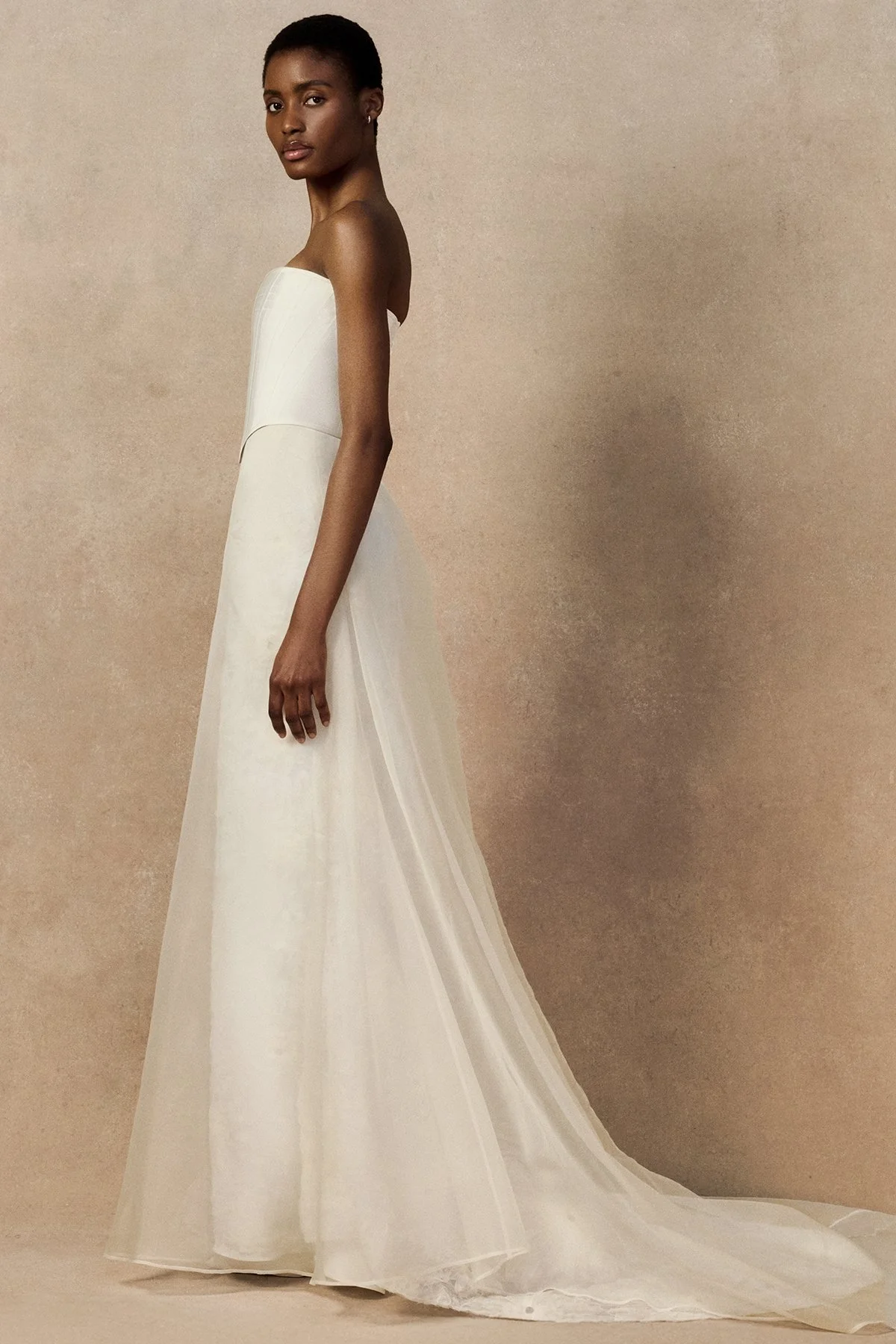 side image of Meg bridal skirt with looped daisies in raw-edged silk organza, and a layered silk organza fit-and-flare skirt.