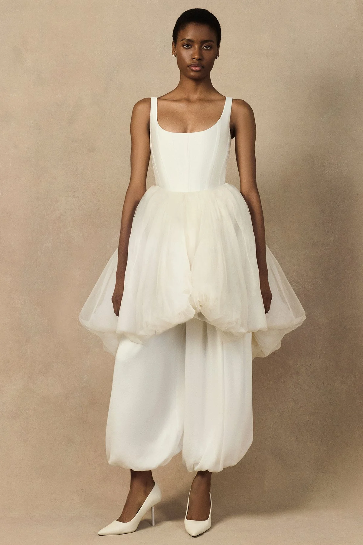 front image of the Penelope Corset with a deep scoop neckline, exaggerated hip silhouette, and visible structural boning with seam lines. with oxana trouser and meg mini skirt