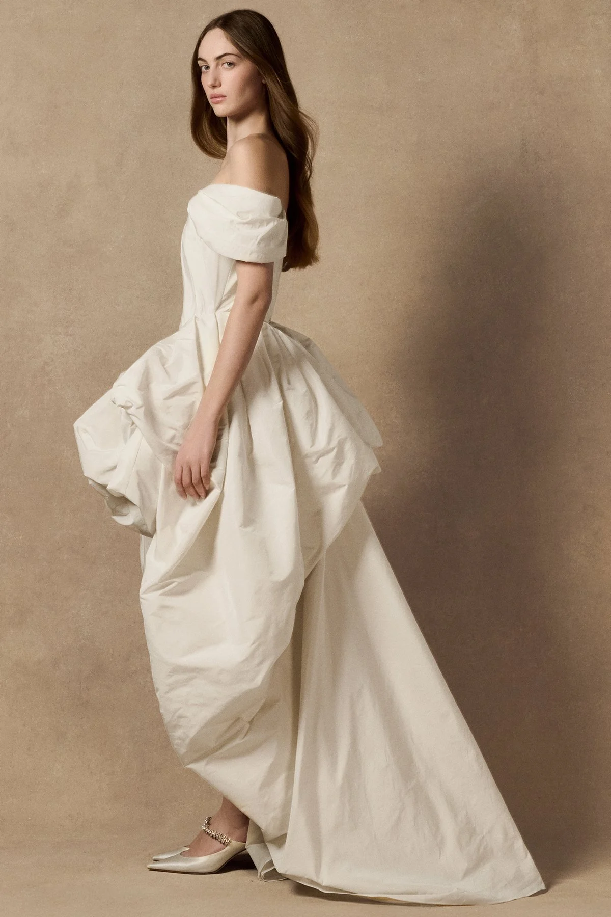 side image of Lubi dress in pleated weightless taffeta, featuring a structured support corset, shown with sleeves and mini skirt