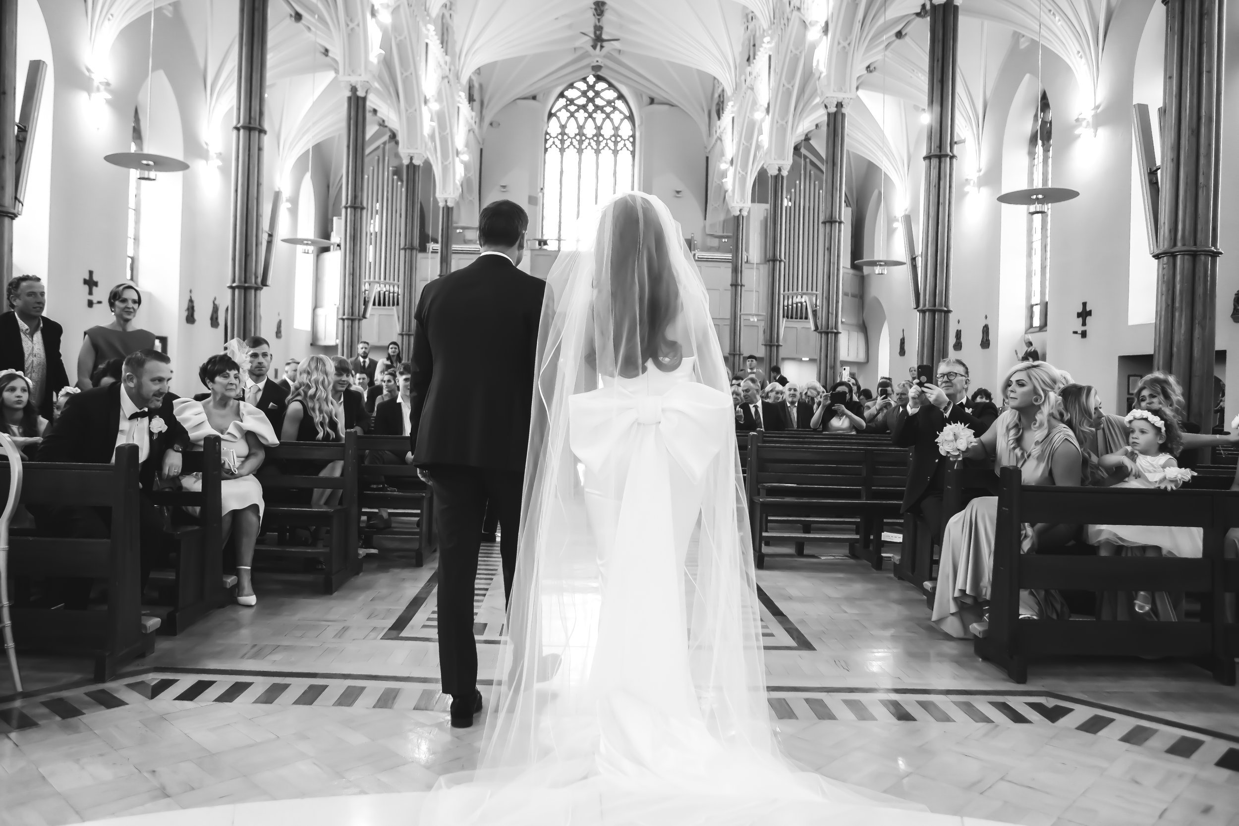 Beautiful bride Ciara wears the Dayton dress and Ariel bow by Halfpenny London