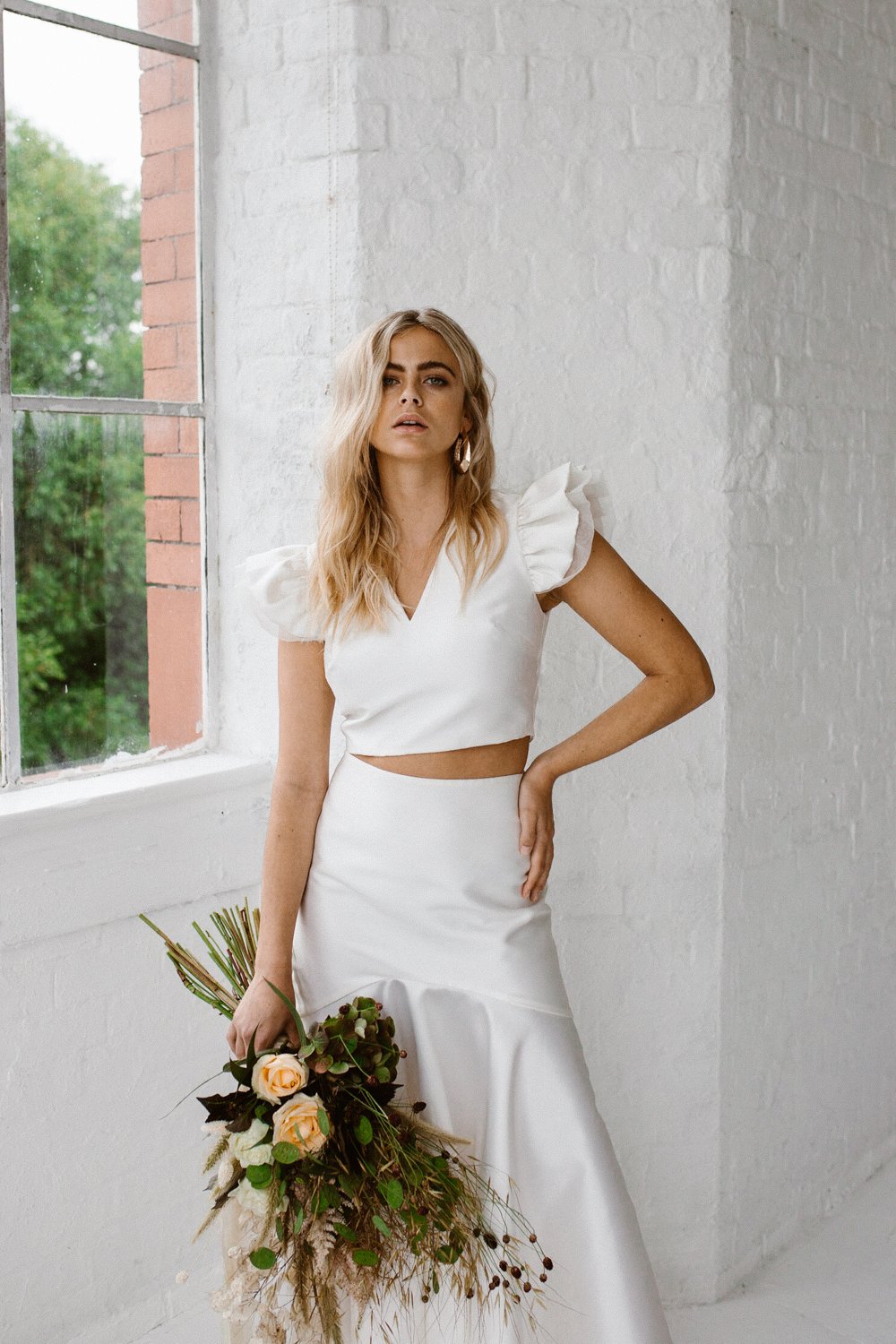 Minimalist bridal style inspiration shoot featuring wedding dresses and bridal wear by Halfpenny London