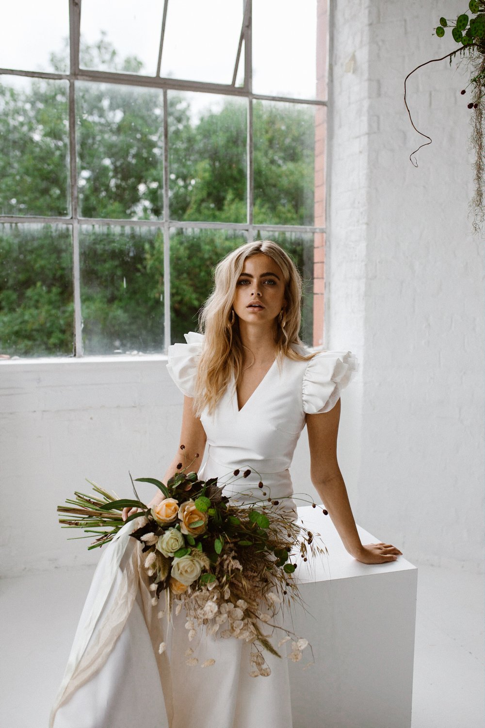 Minimalist bridal style inspiration shoot featuring wedding dresses and bridal wear by Halfpenny London