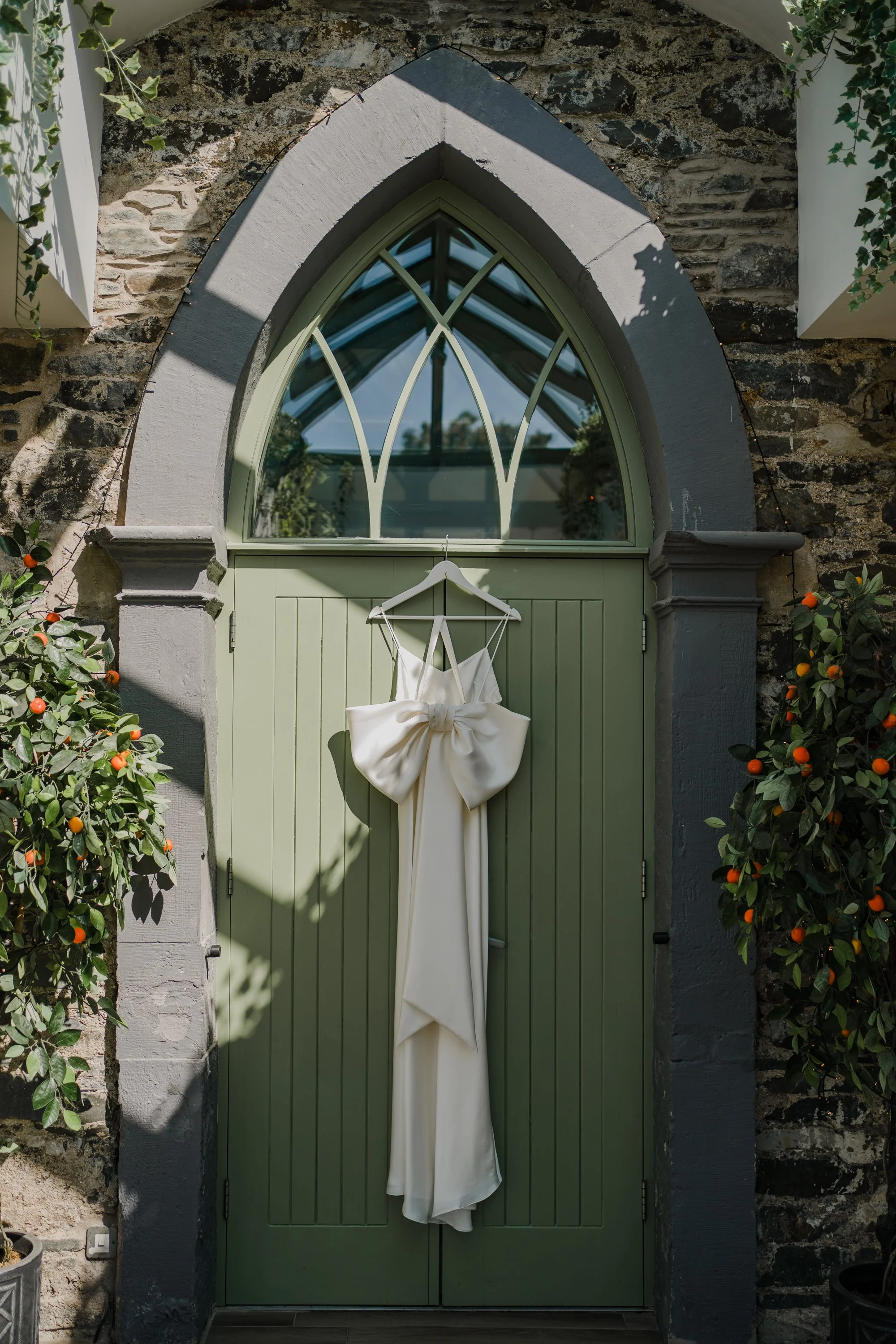 Beautiful bride Astrid wears the Iris slip and Ariel bow | Wedding dresses by Halfpenny London