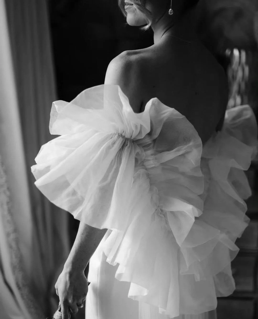 Oversized organza frills cascade from the arms, creating a dreamy back detail. The Issa shrug is a soft, sculptural layer over any of our base dresses or styled with separates. ⁠
⁠
Discover how some of our Halfpenny London brides have styled it throu