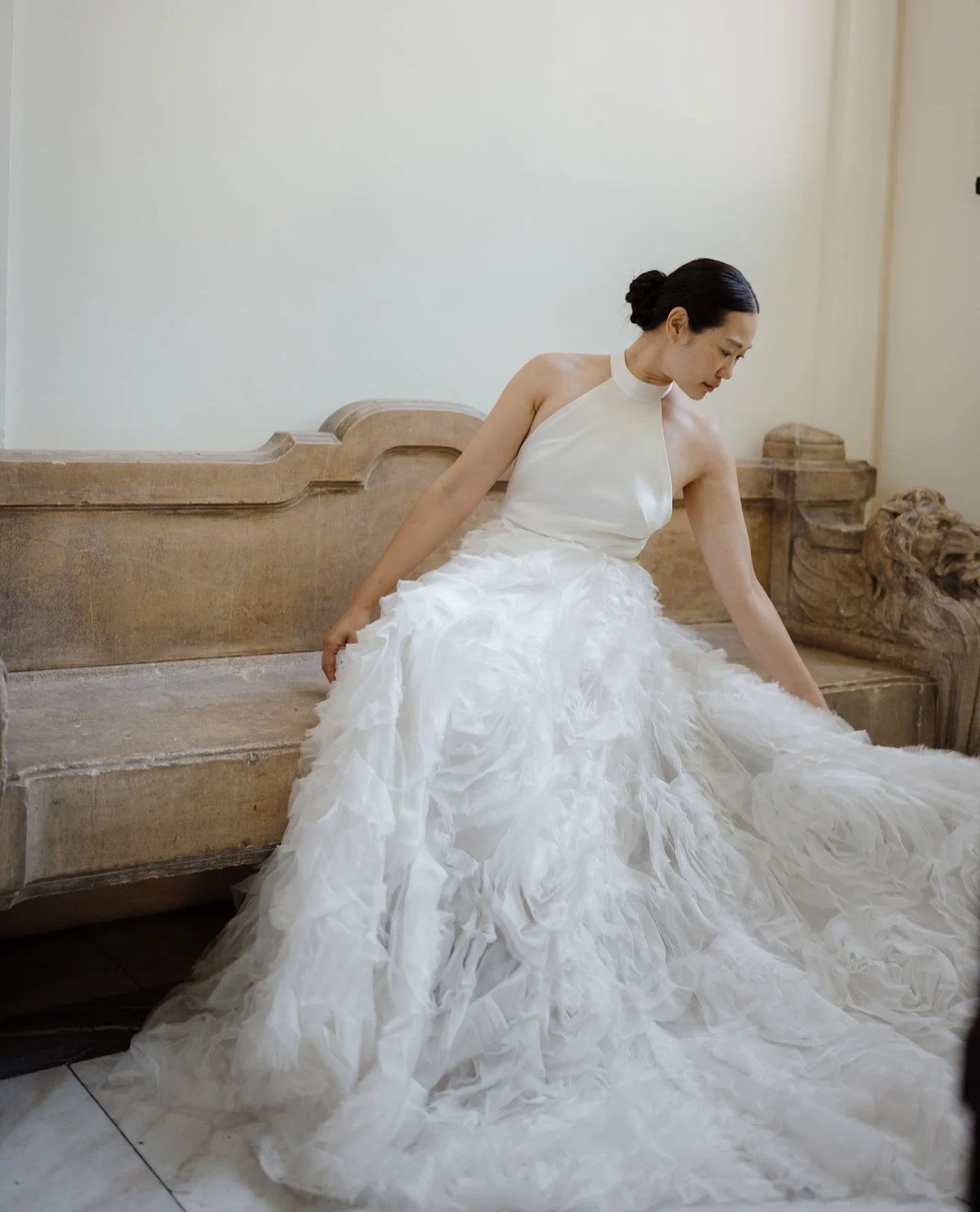 Voluminous romance. The Ruffle Rose skirt is a double-layered organza dream, styled here with the open-back Summer dress and Kerry veil. The statement overskirt also comes as a playful mini &mdash; for a day-to-night transformation.⁠
⁠
Book an appoin