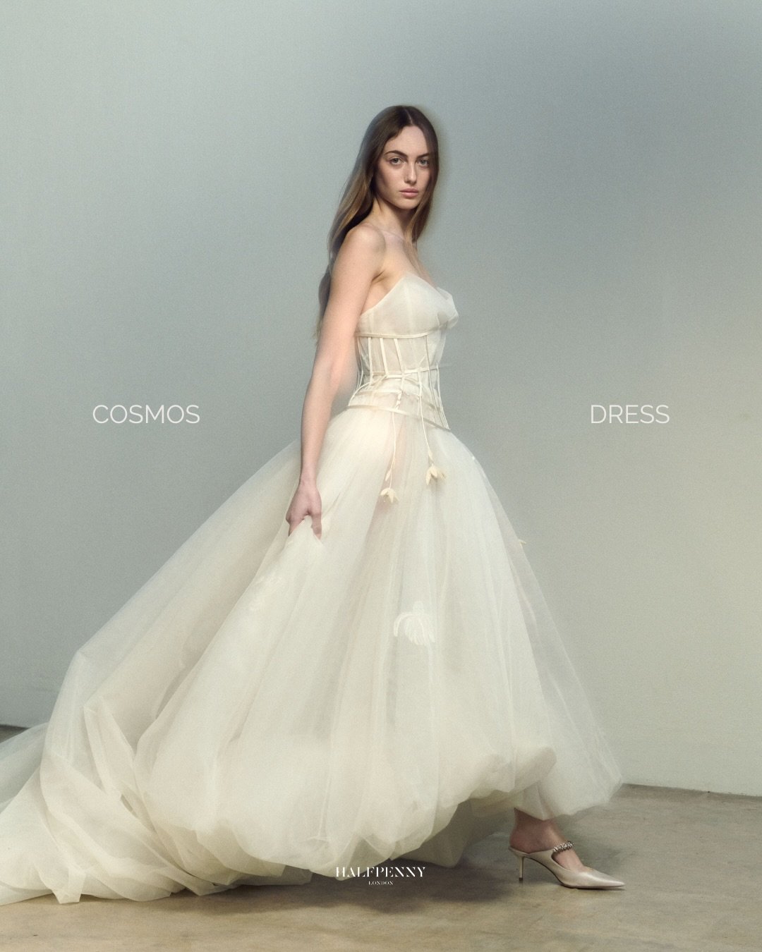 The Cosmos dress.⁠
⁠
Layers of delicate tulle sit over an exposed corset, with echinacea embroidery suspended within a sculptural silhouette. A featherlight crinoline creates volume without weight.⁠ Fragility, held in place by structure.⁠
⁠
Book your