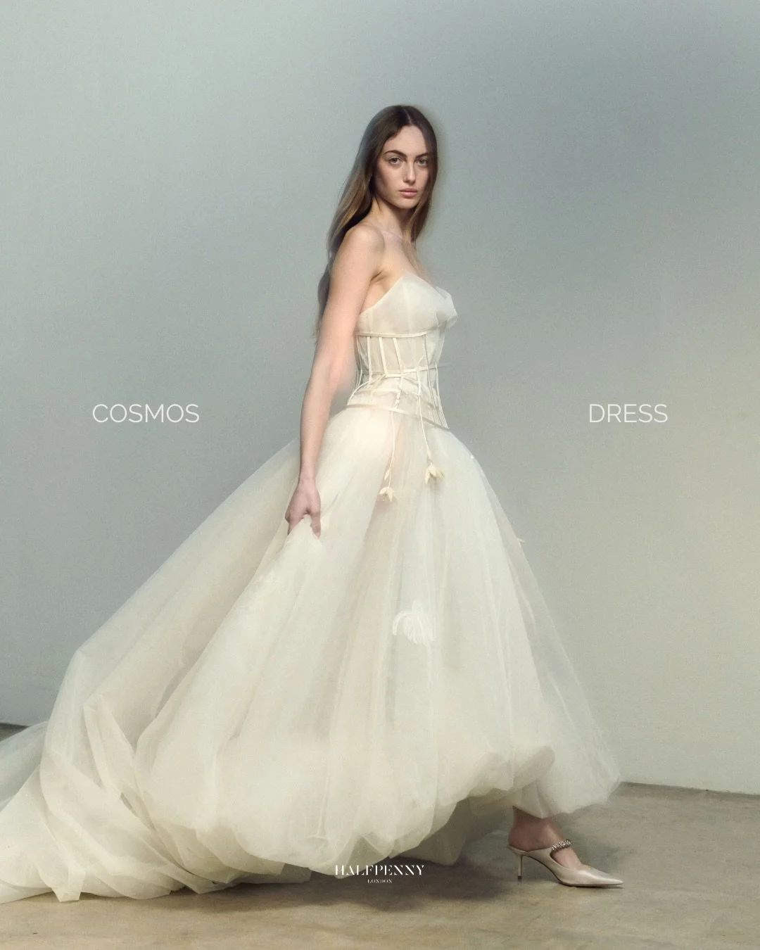 The Cosmos dress.⁠
⁠
Layers of delicate tulle sit over an exposed corset, with echinacea embroidery suspended within a sculptural silhouette. A featherlight crinoline creates volume without weight.⁠ Fragility, held in place by structure.⁠
⁠
Book your