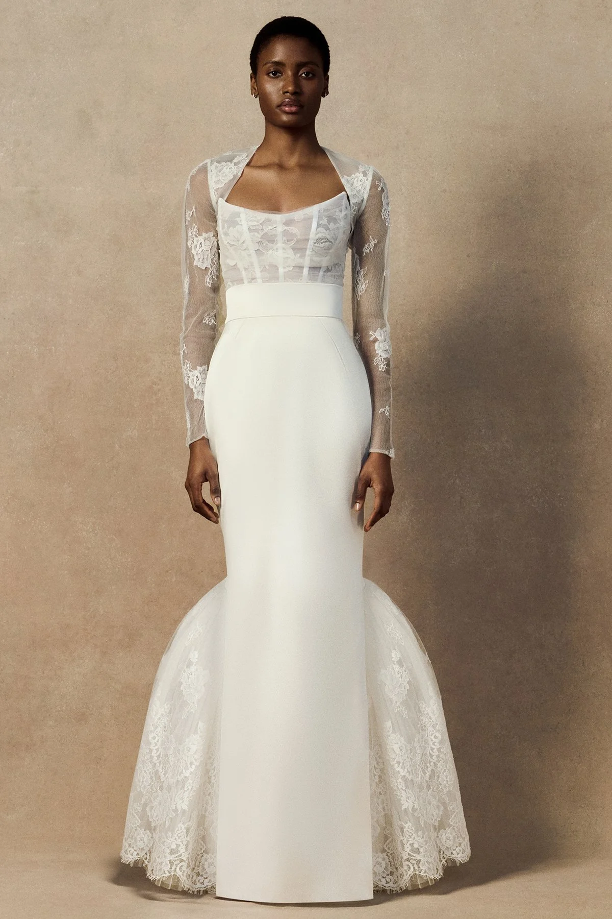 front image of Mila Rae Skirt in Duchess Satin featuring a form-fitting silhouette and a modern bustle train supported by layers of pleated tulle and French Peony lace.