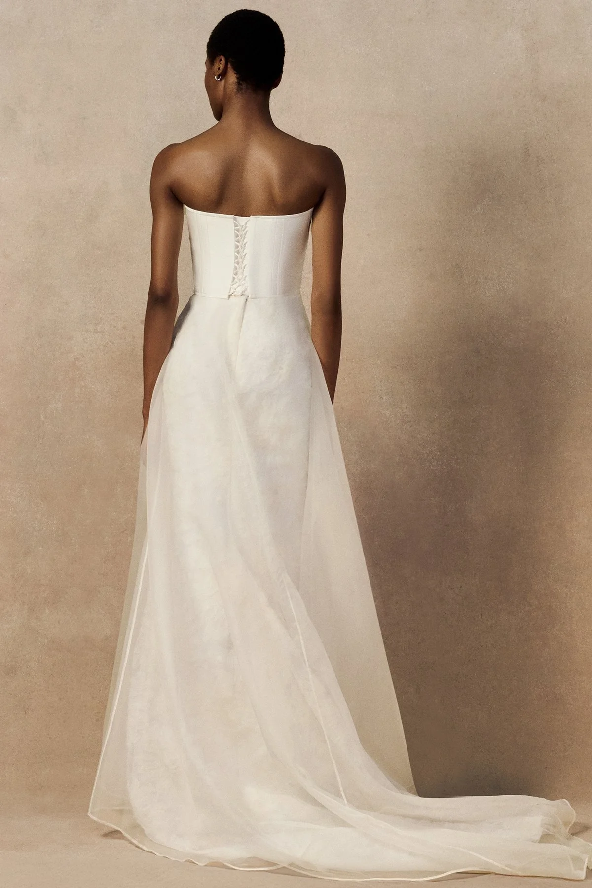 back image of Meg bridal skirt with looped daisies in raw-edged silk organza, and a layered silk organza fit-and-flare skirt.