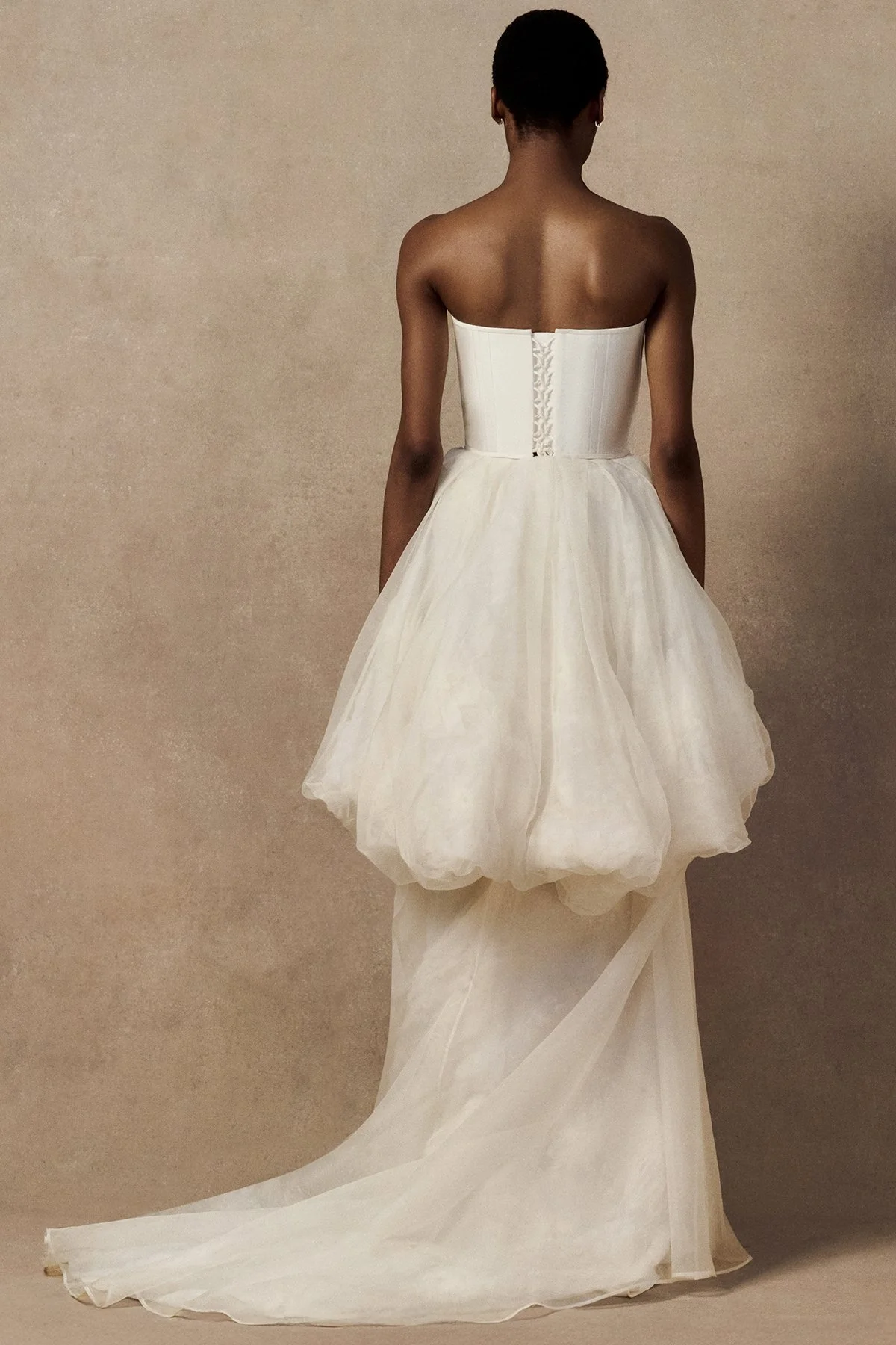 back image of Meg Mini skirt featuring looped daisy motifs in a bubble-shaped silhouette with a high-low hem. worn with phoenix corset and meg skirt