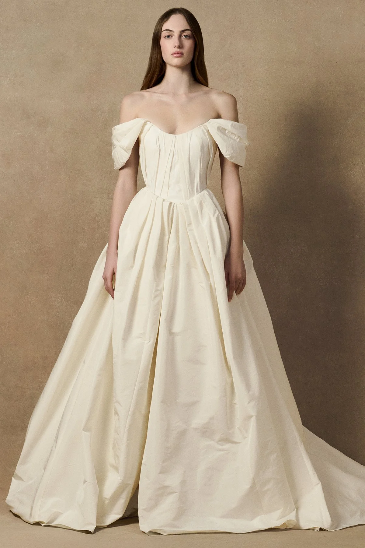 front image of Lubi dress in pleated weightless taffeta, featuring a structured support corset, shown with sleeves and full length gown