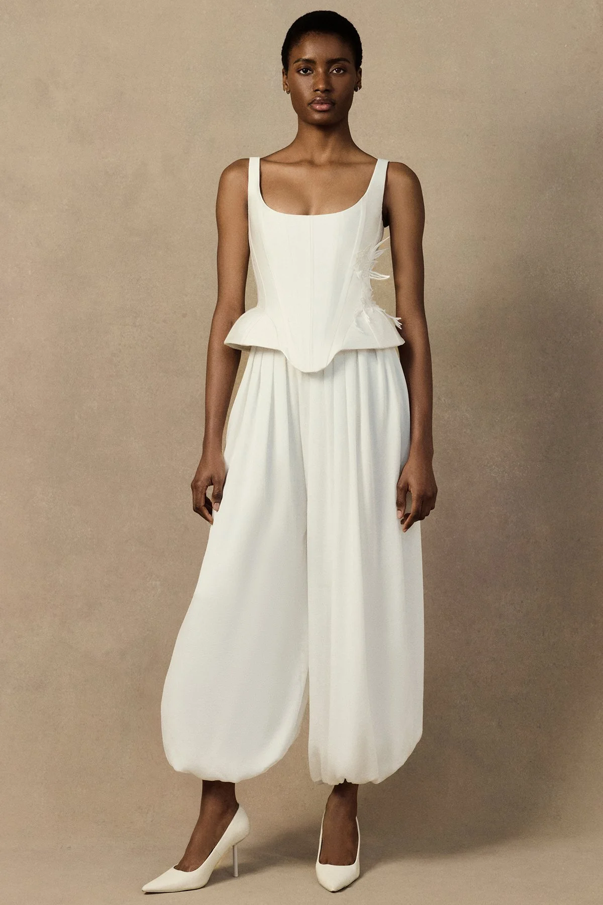 front image of the Penelope Corset with a deep scoop neckline, exaggerated hip silhouette, and visible structural boning with seam lines. with oxana trouser and embroidery