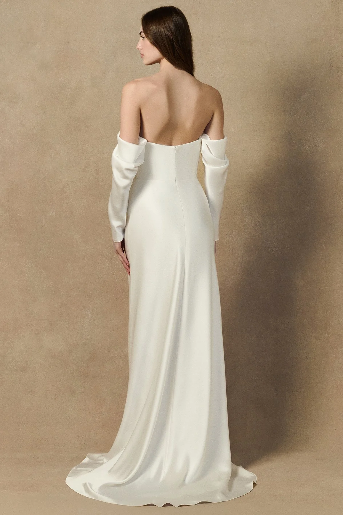 back image of Herah Dress in liquid crepe back satin featuring a cowl neckline, lace trim details, and an draped skirt. worn with sleeves