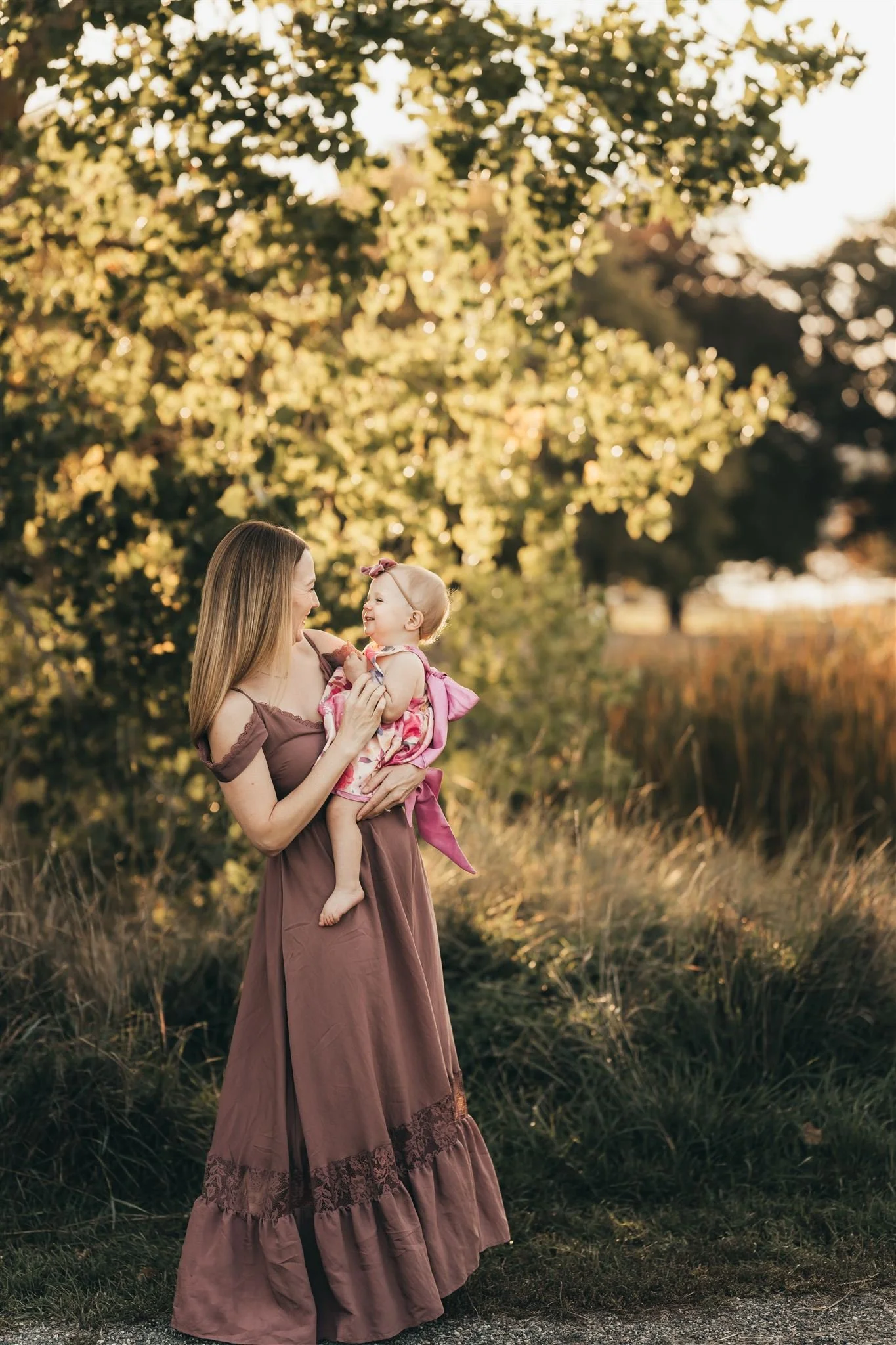 Denver Family Photographer | Mother holds baby in City Park in Denver, Colorado