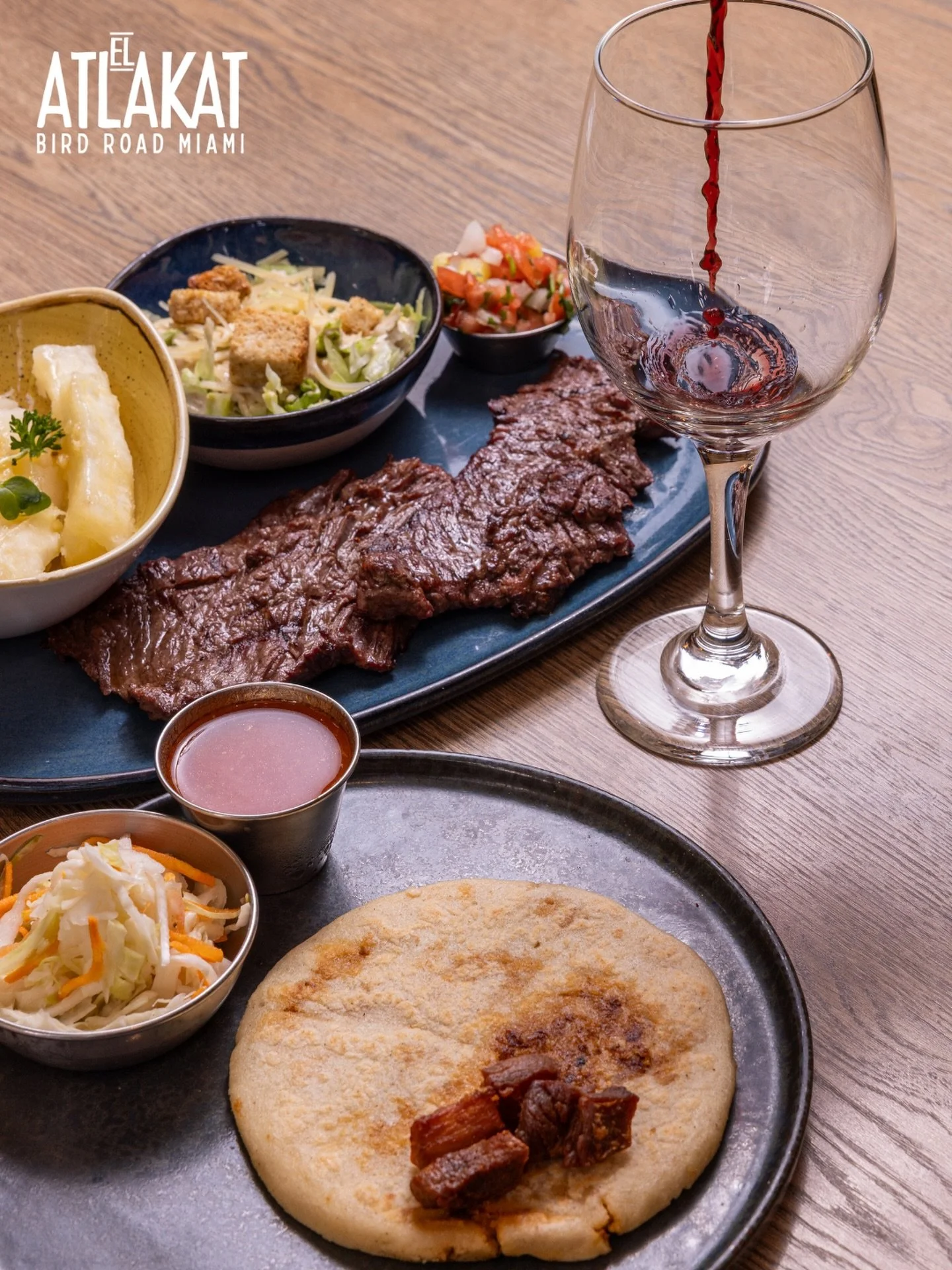 Grilled steak, a handmade chicharr&oacute;n pupusa and a glass of red wine. This is what the perfect lunch looks like. ✨

ONLY AT BIRD ROAD: 9425 S.W. 40th. Street. Miami, FL 33165&nbsp;
💻 Orders, delivery and reservations at www.elatlakat.com
☎️ (3