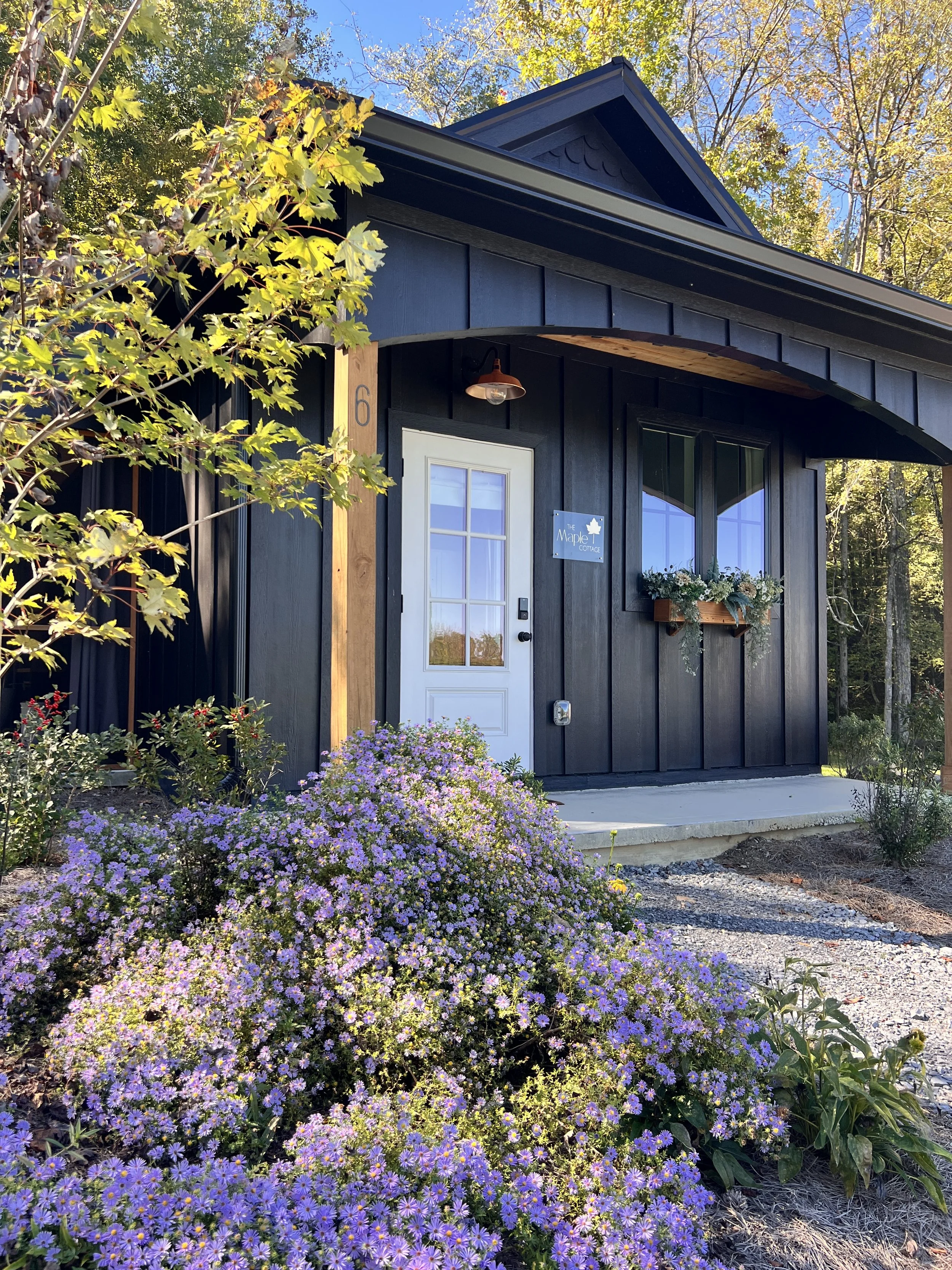 Exterior Image of Maple Cottage's front porch and front door with gravel sidewalk leading to it