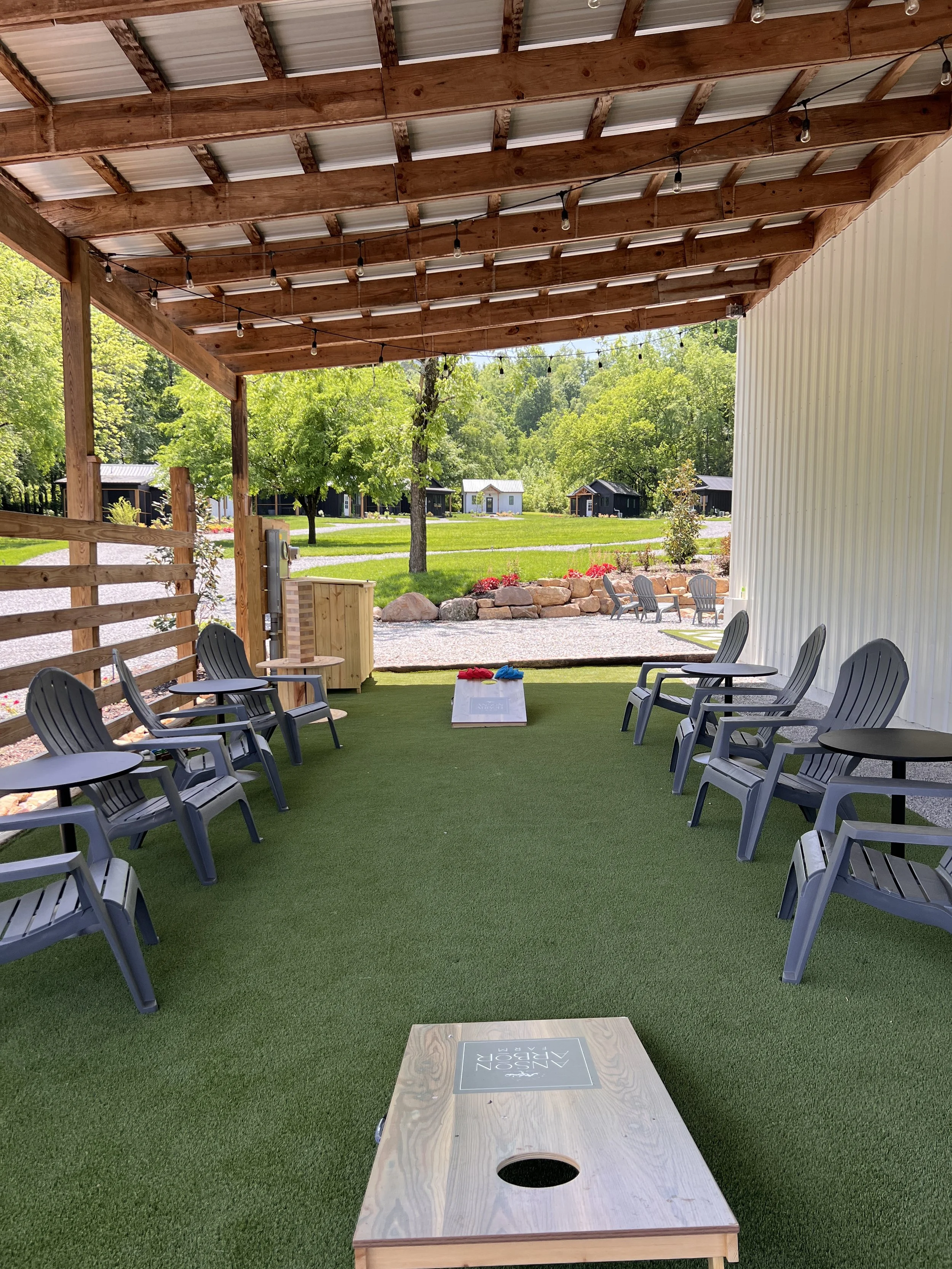 Outdoor seating area with cornhole boards