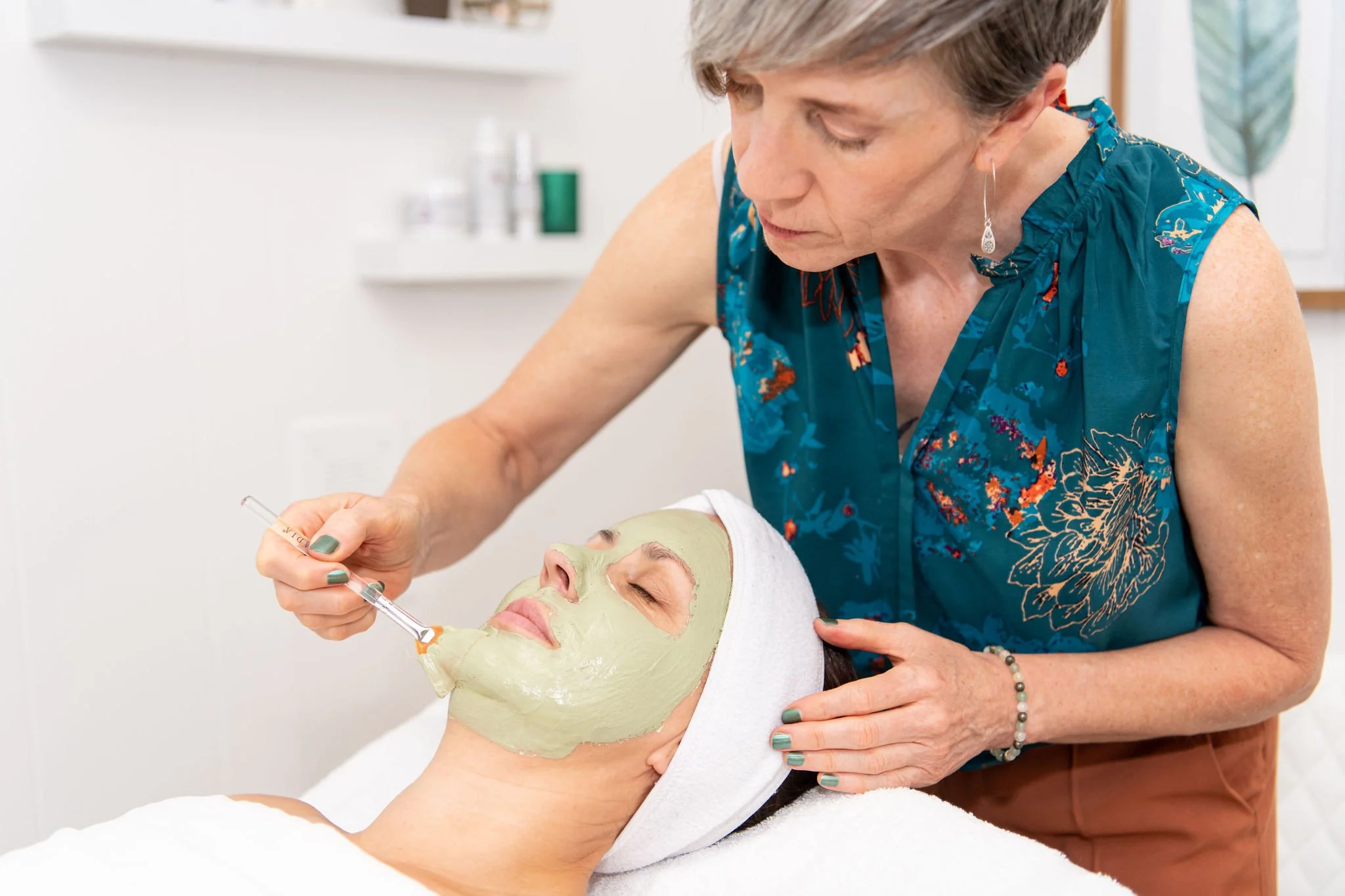 Client receiving an organic, holistic facial to reduce fine lines and wrinkles.