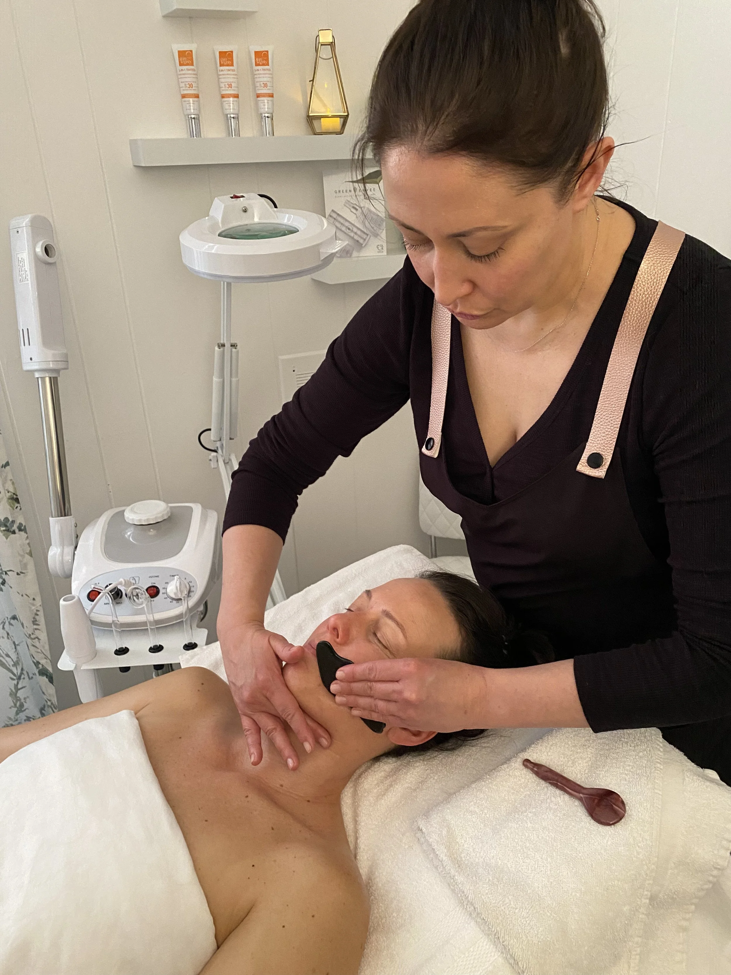 Client receiving an organic gua sha facial