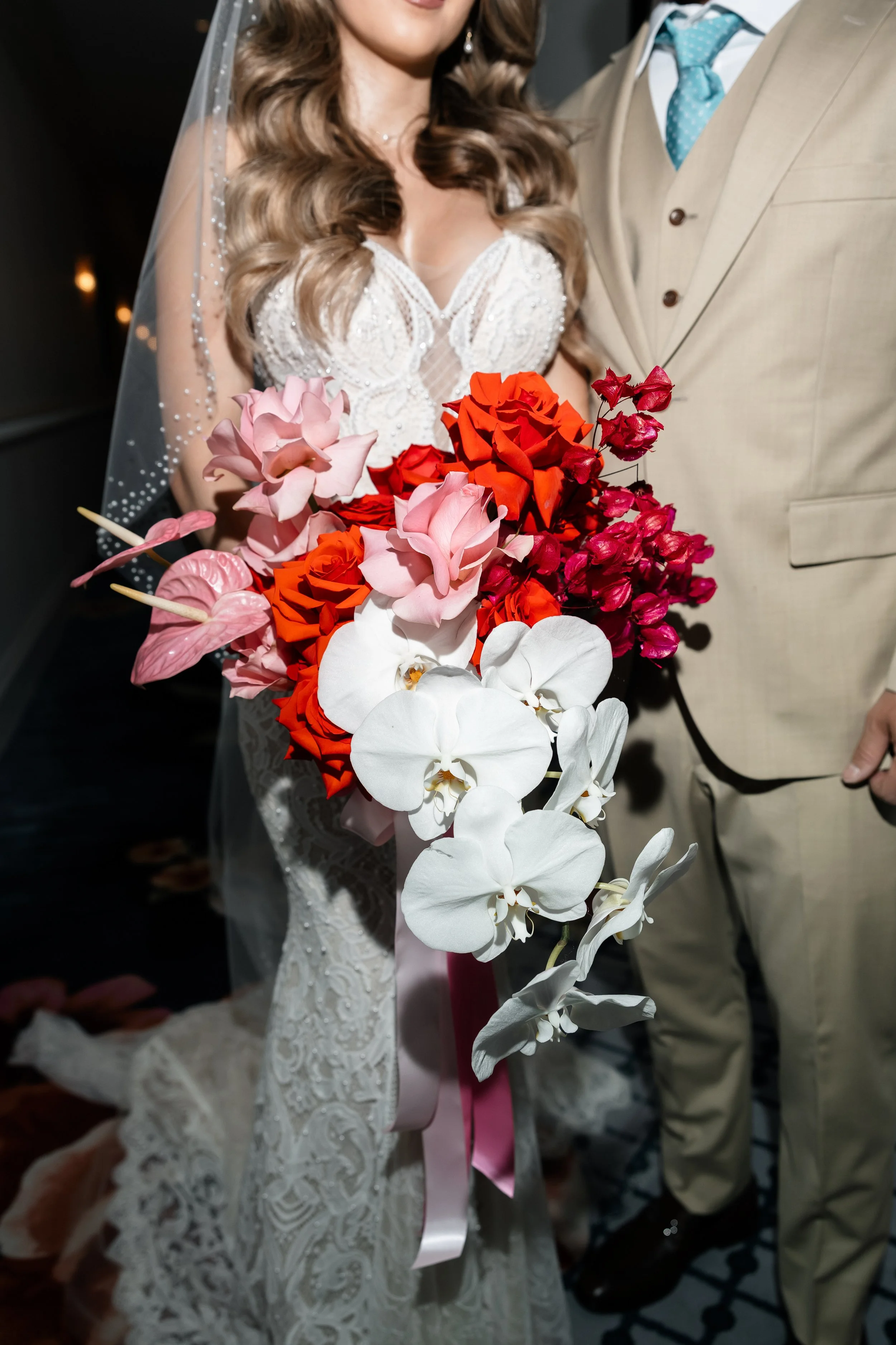 Las Vegas elopement bouquet of coral roses, blush garden roses, pink anthurium and cascading white phalaenopsis orchids, designed by Thistle House