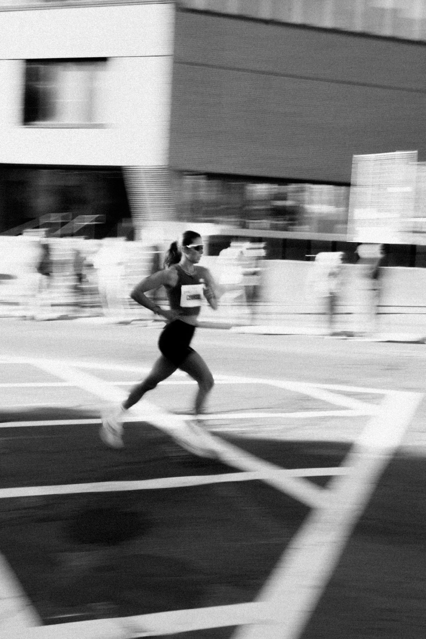 woman running a race. blurred. black and white