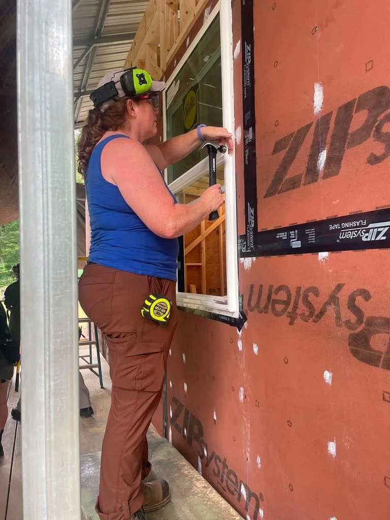 Susie installing a window