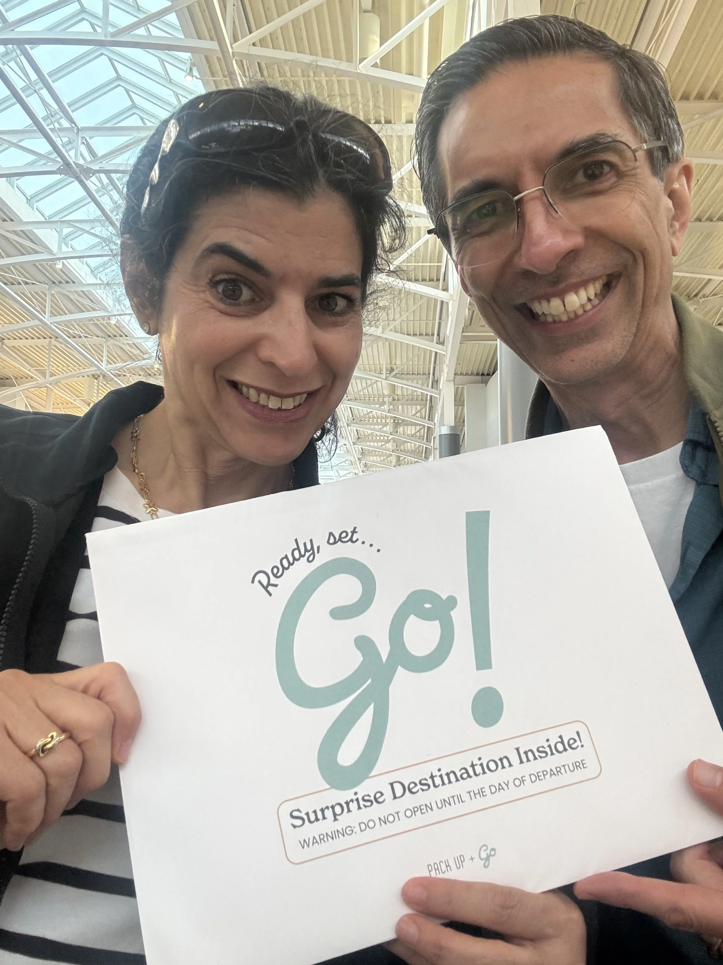 Pack Up + Go travelers opening their surprise envelope