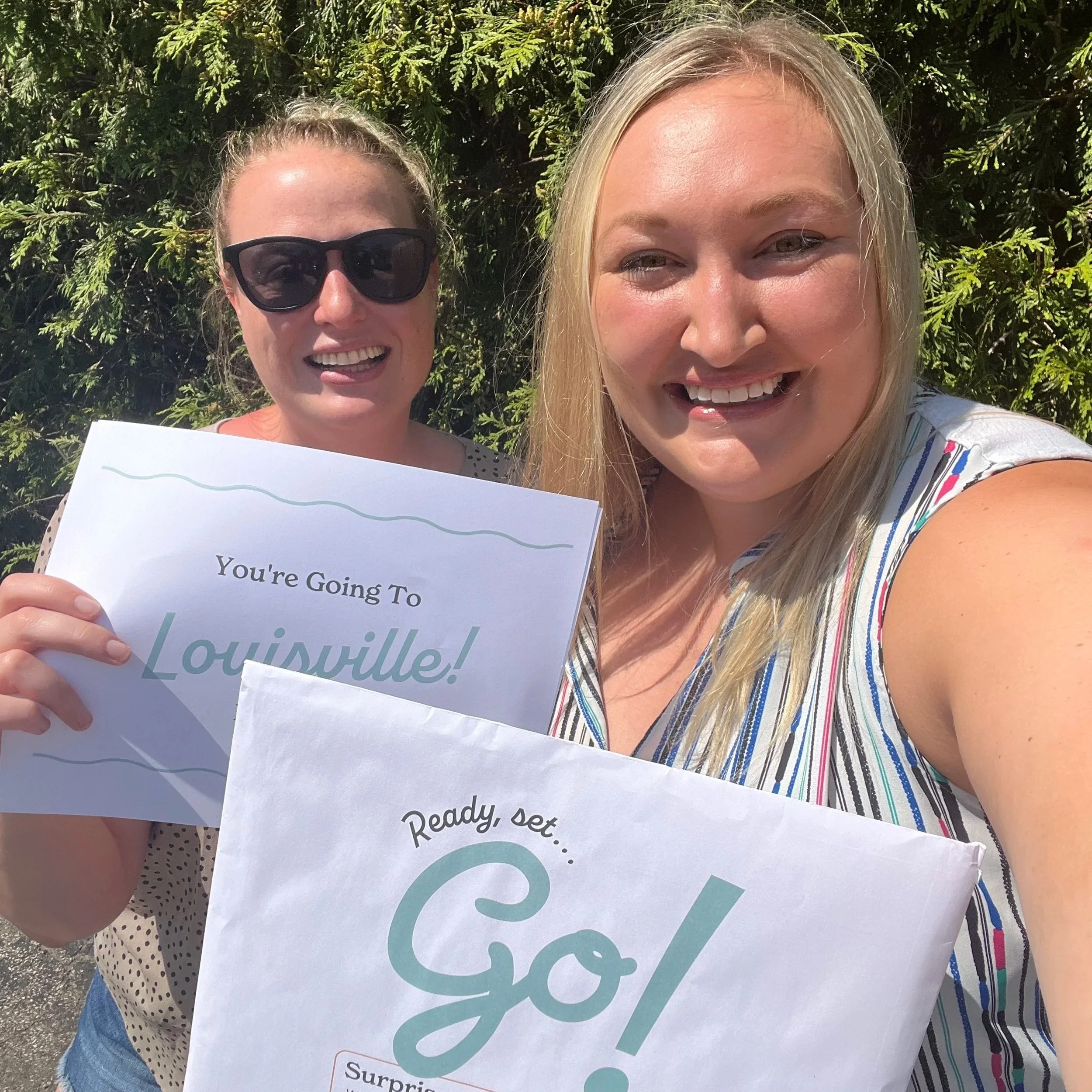Pack Up + Go travelers opening their surprise envelope