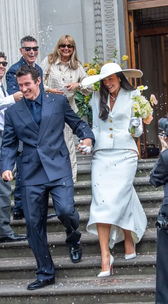 Dua Lipa in two piece suit by Danial Roseberry and hat by Stephen Jones. Two piece dresses available at The Aisle Skipton