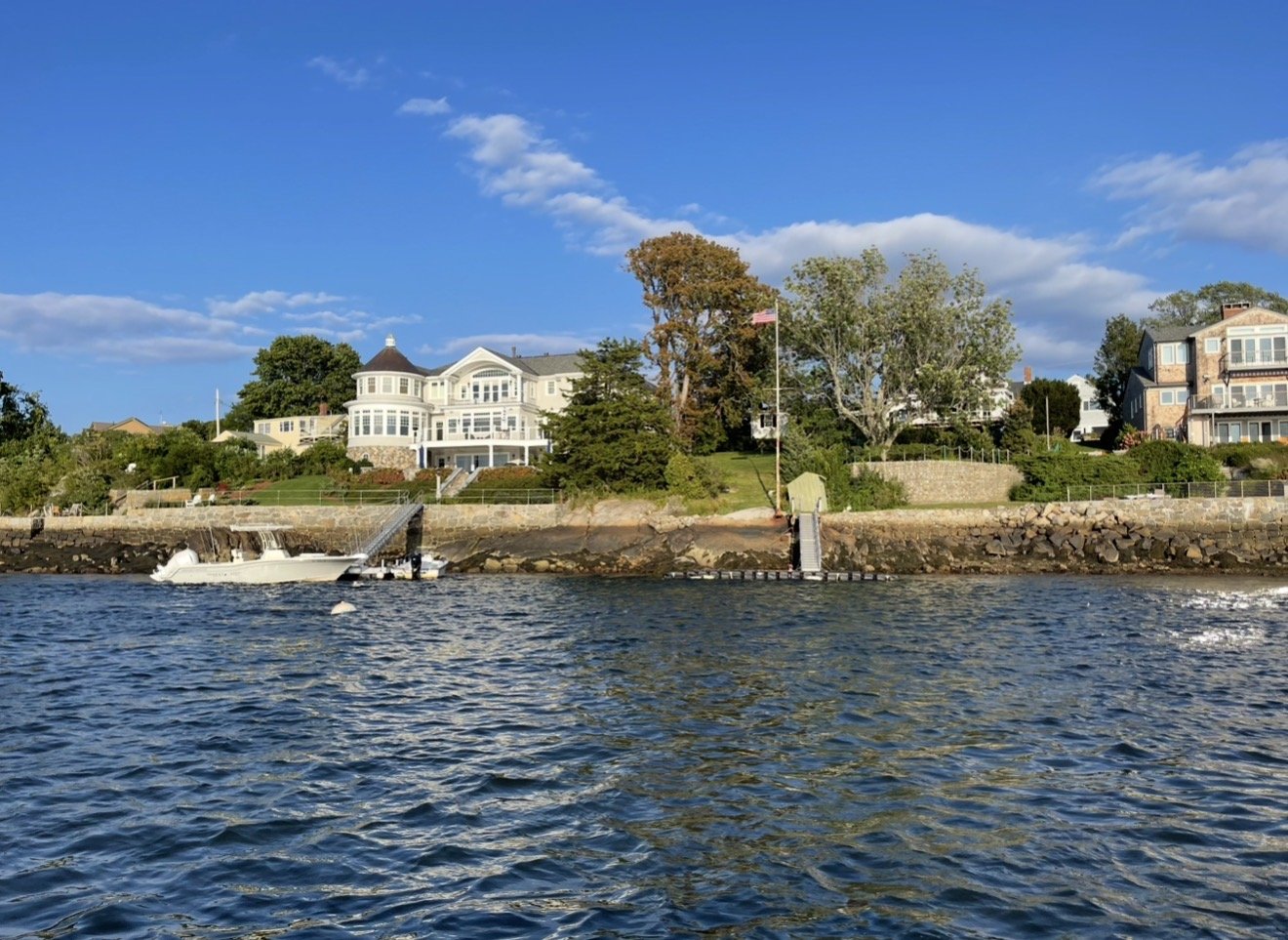 Glide past New England waterfront homes, boats, and quiet coves.