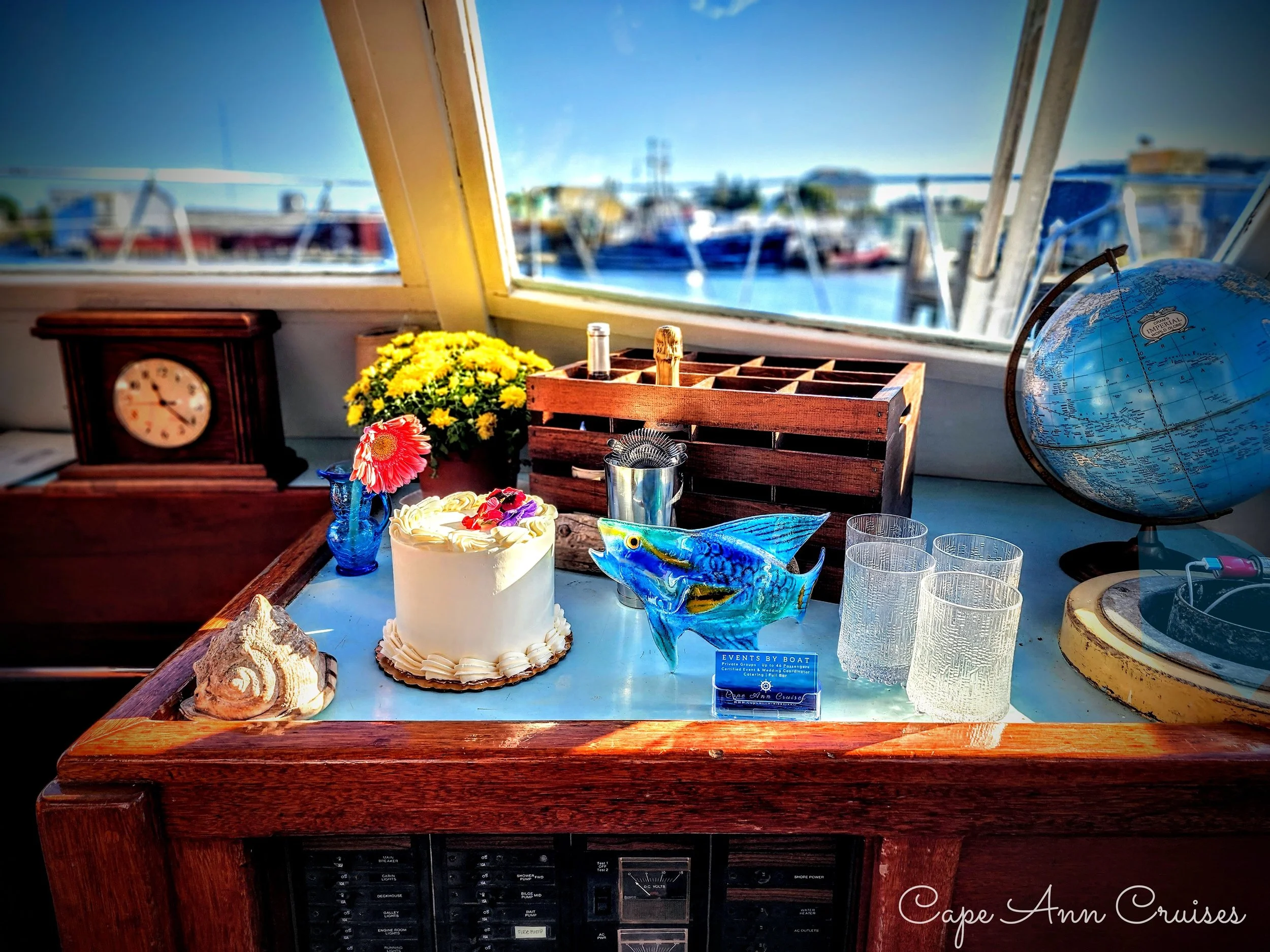wedding-cake-on-a-yacht-with-wedding-flowers-and-boats-nautical-wedding-them-picture.jpg