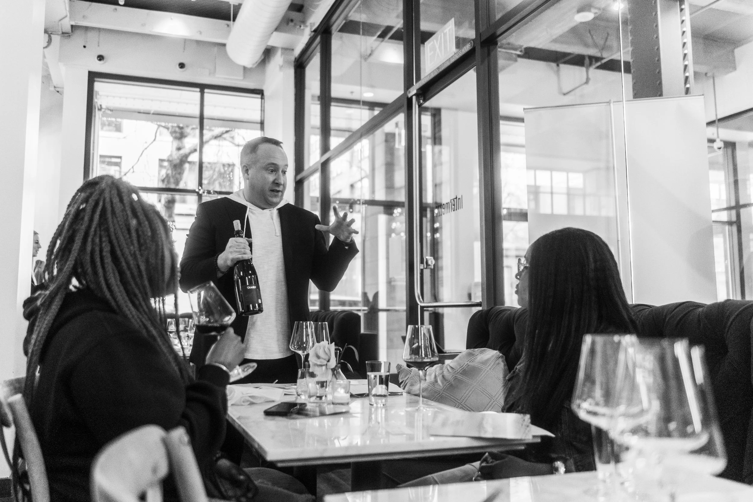 Tim Lenihan explaining Dossier wine to two women