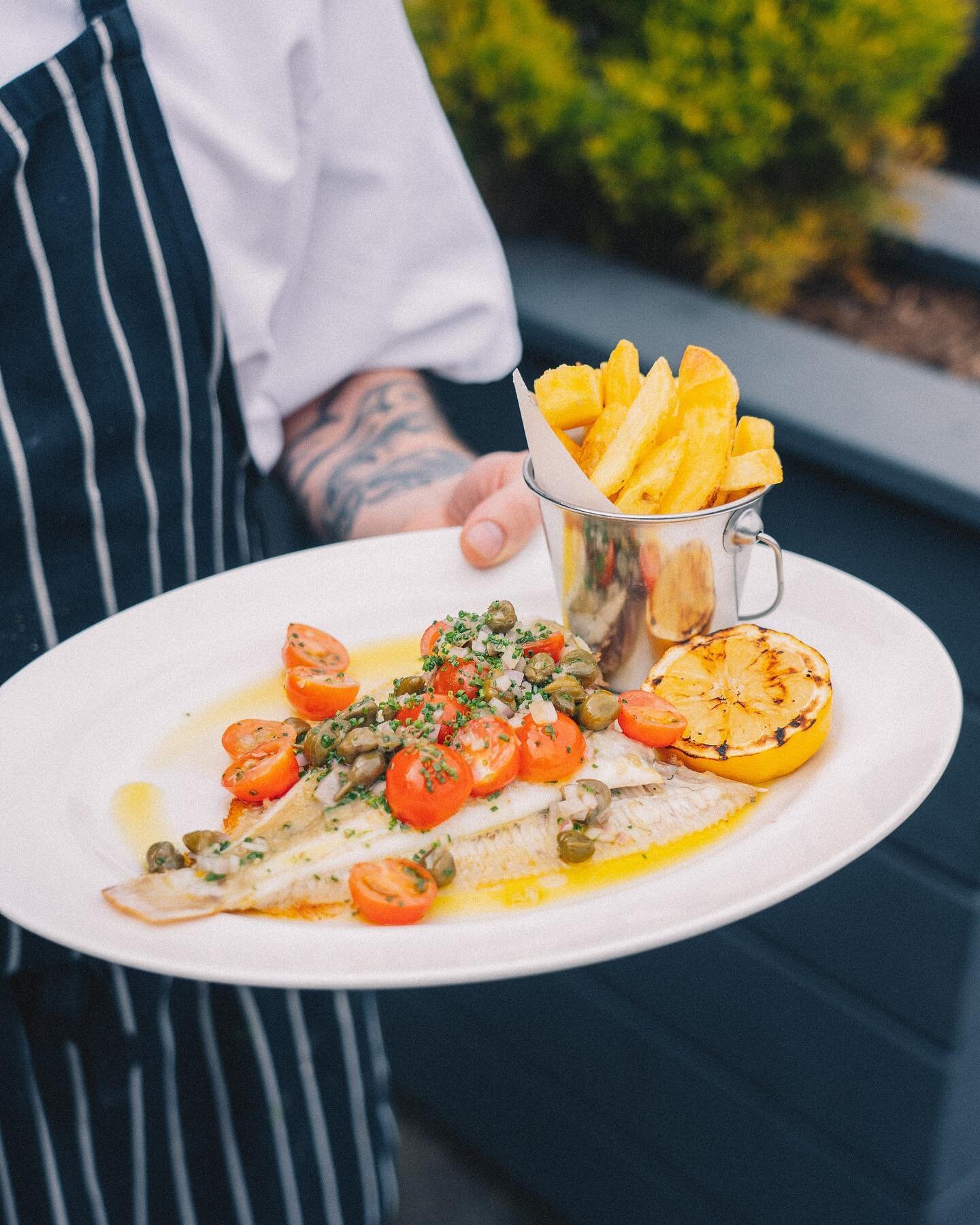 New menu 🎣 Introducing one of our new seafood dishes 👉 Whole Plaice with hand cut chips, shallots, capers &amp; cherry tomatoes. The perfect al fresco summer dish ☀️ 

Link in bio to book a table indoors or on our terrace 🙏