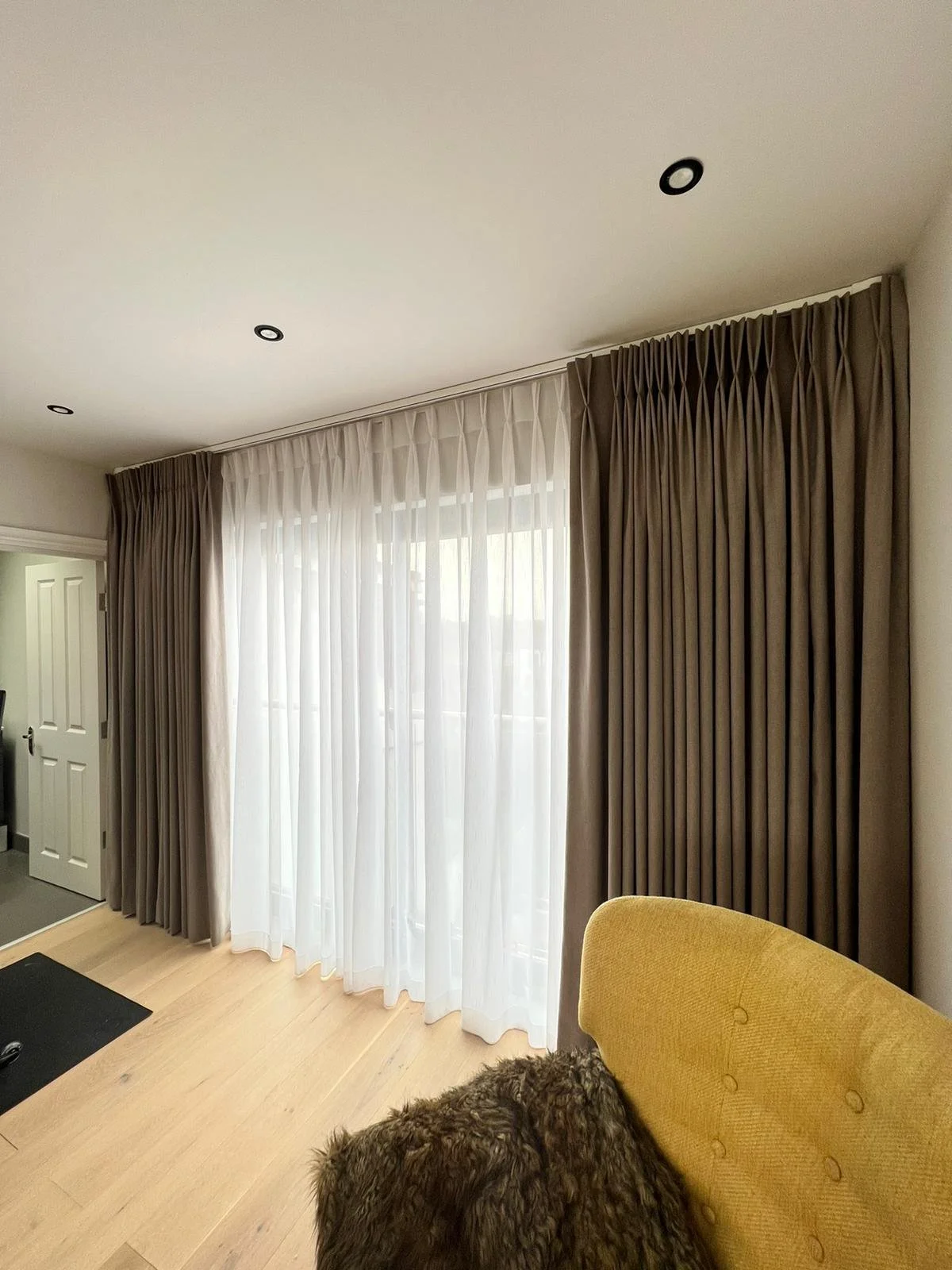 Quintessential London - Pair of curtains on Somfy Electric Track accompanied by a pair of voiles on a manual track