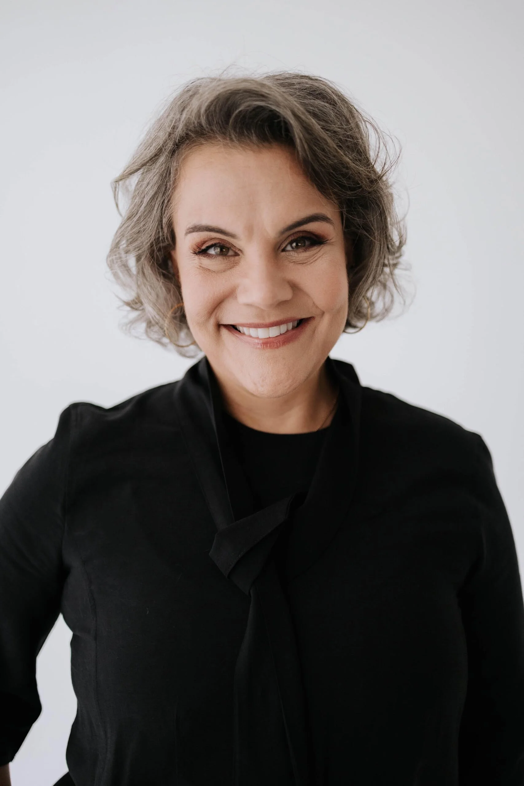 image of Graci Selaimen smiling into the camera in a black top