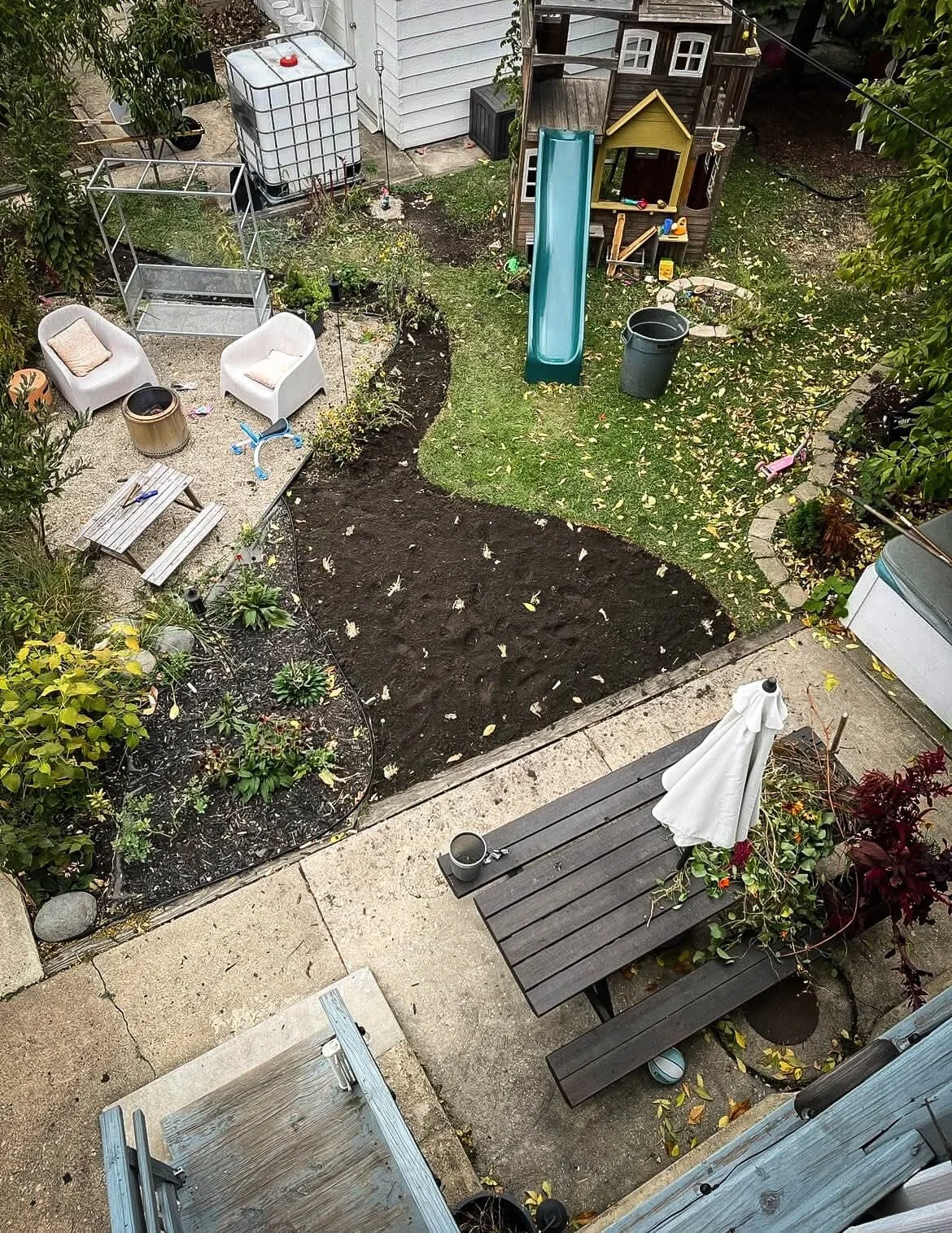 Gardens designed for both habitat and everyday living. Backyard with native planting, patio seating, and family play area.