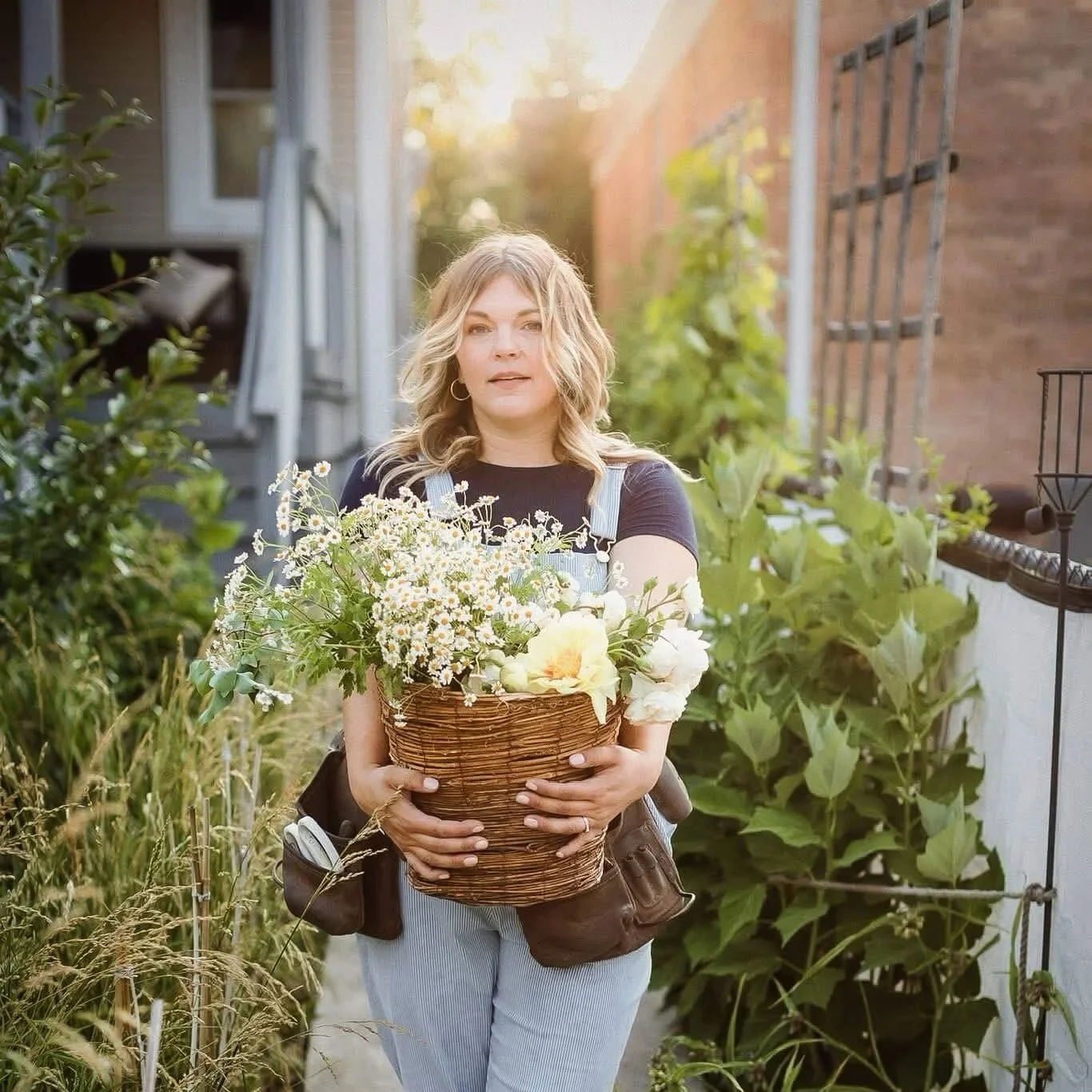 Julia, Chicagoland native garden designer with Spoke Pockette, in a residential backyard garden in Chicago.