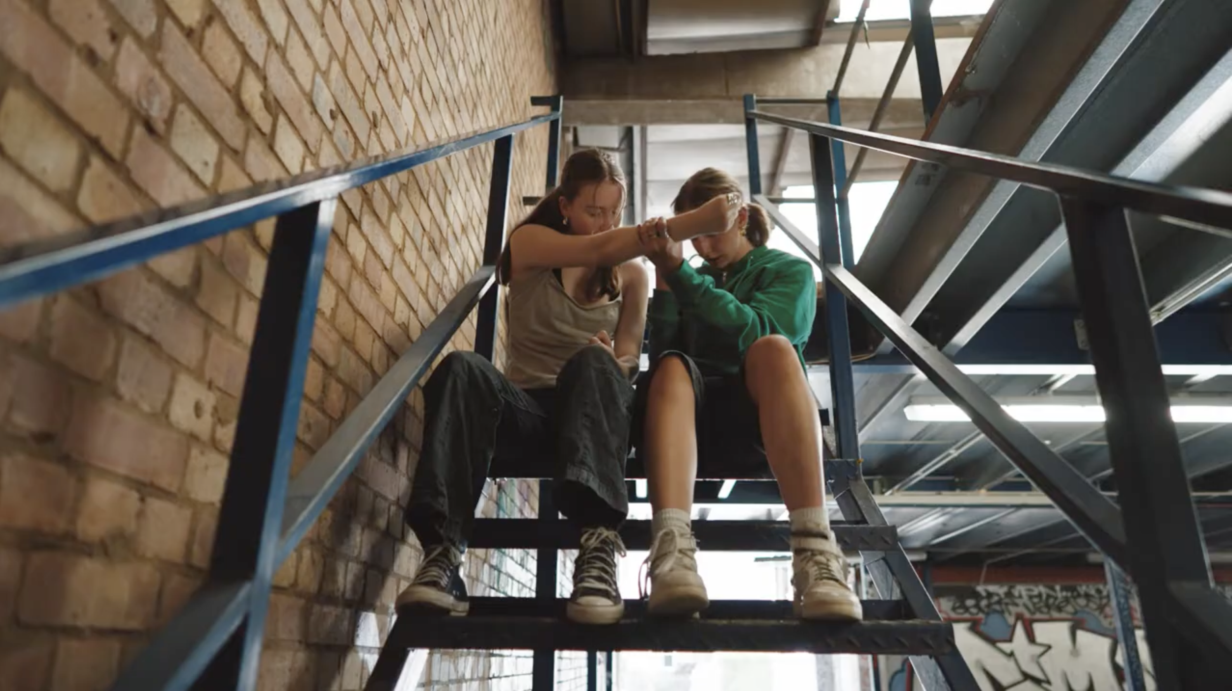 Two dancers sitting on the stairs