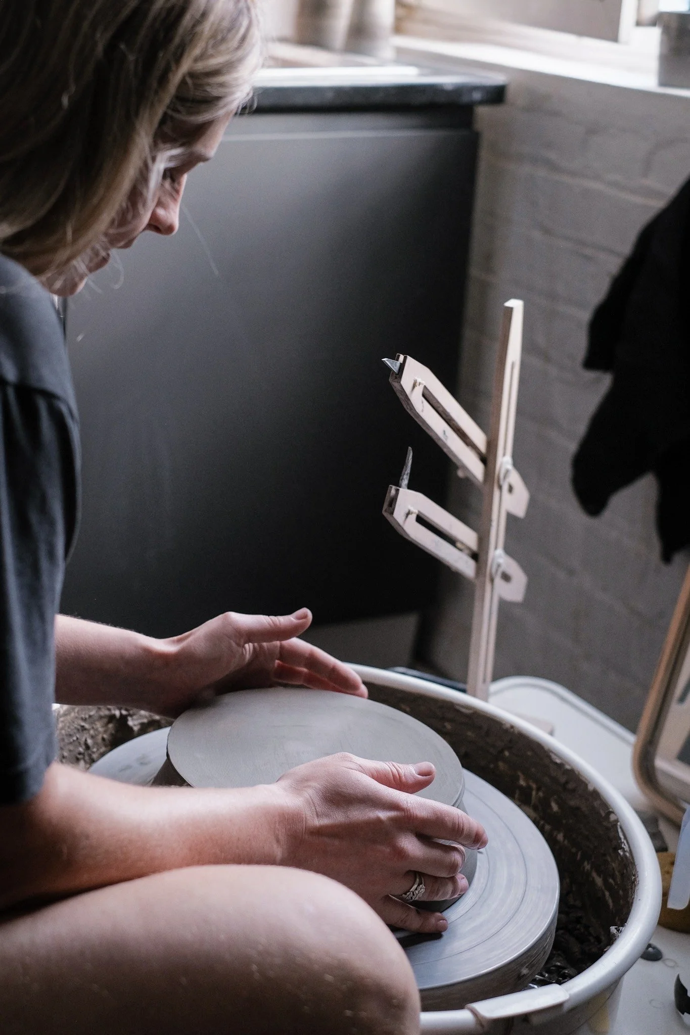 Emma, working at the potters wheel in her pottery studio