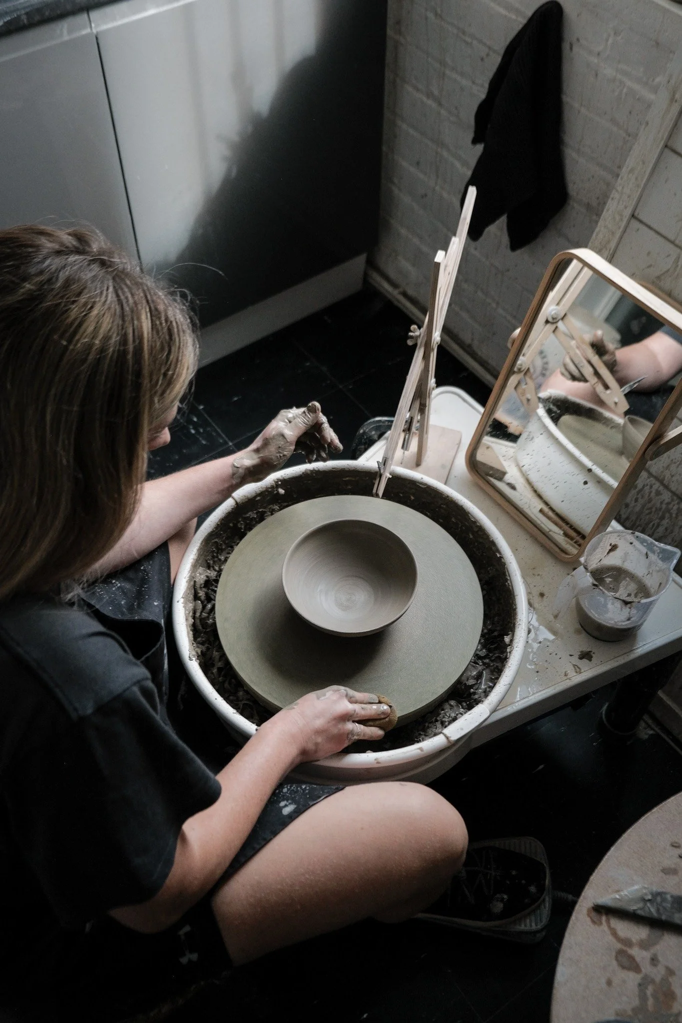 Emma, potter based in Macclesfield on the pottery wheel
