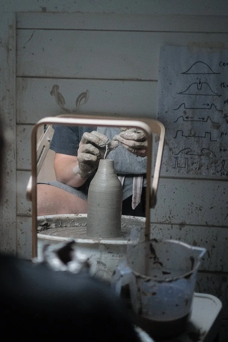 Emma, working at the pottery wheel during a pottery class in Macclesfield